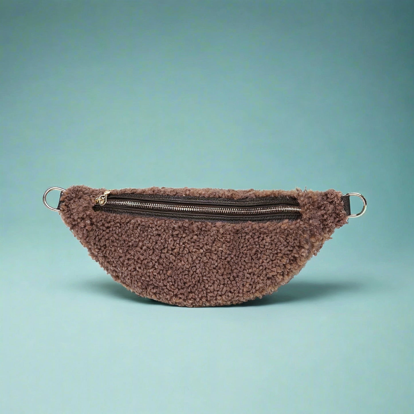 Nevina shearling and leather bum bag in taupe on a teal studio background