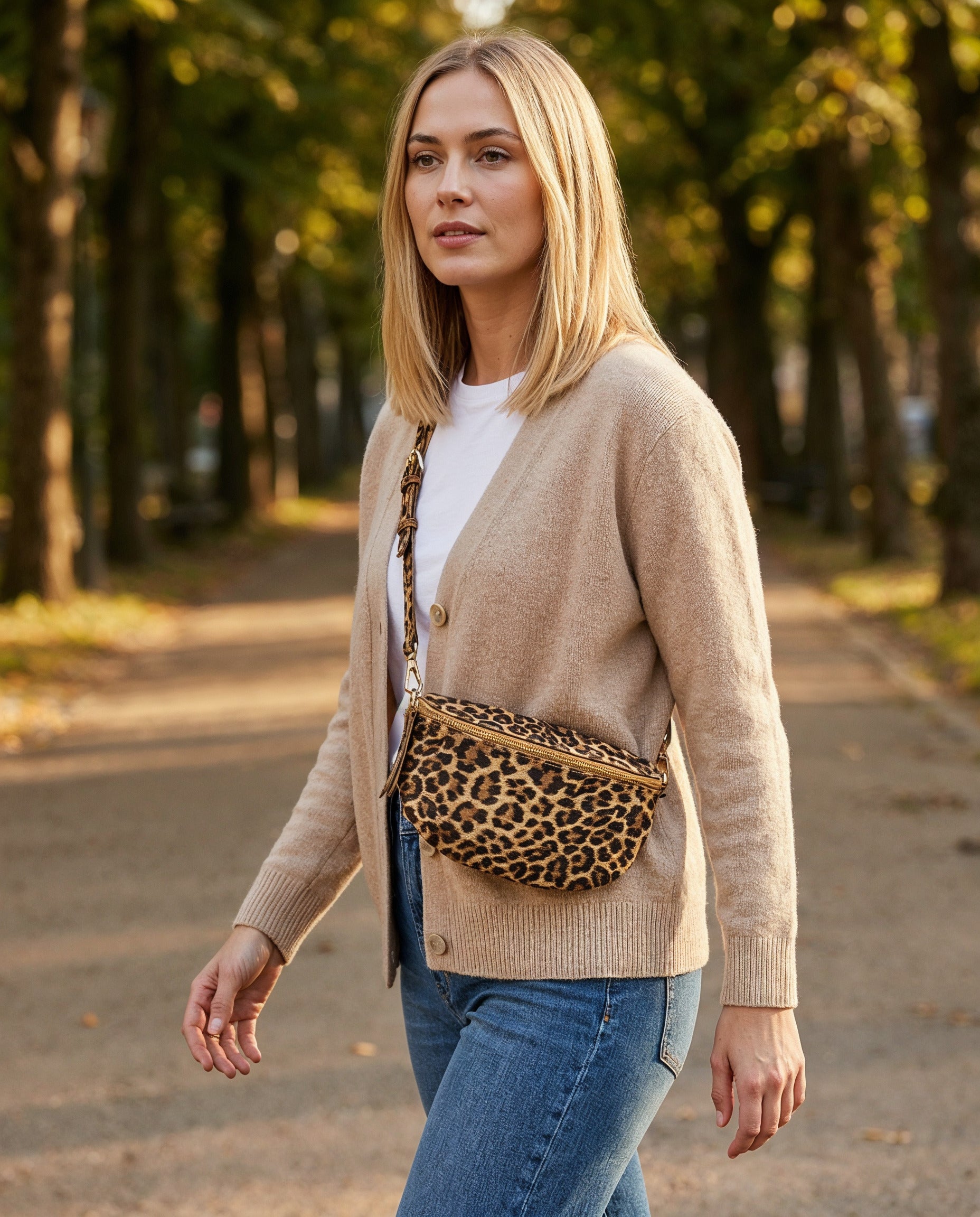Woman with the Golden Leopard Romy bum bag in a park at golden hour