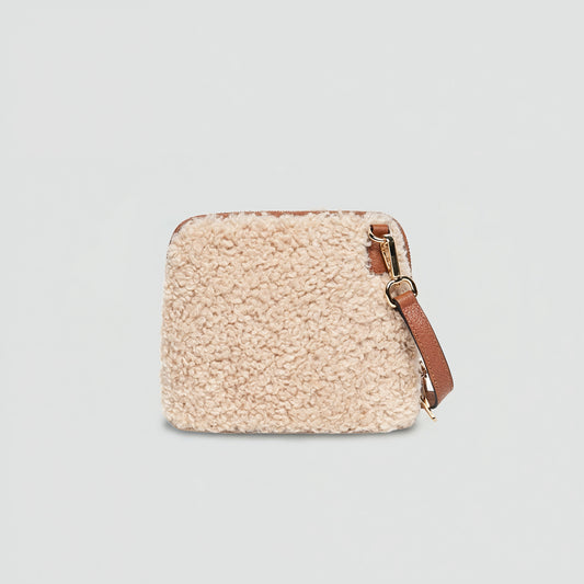 Zita faux shearling crossbody bag in tan, front view on a light grey studio background