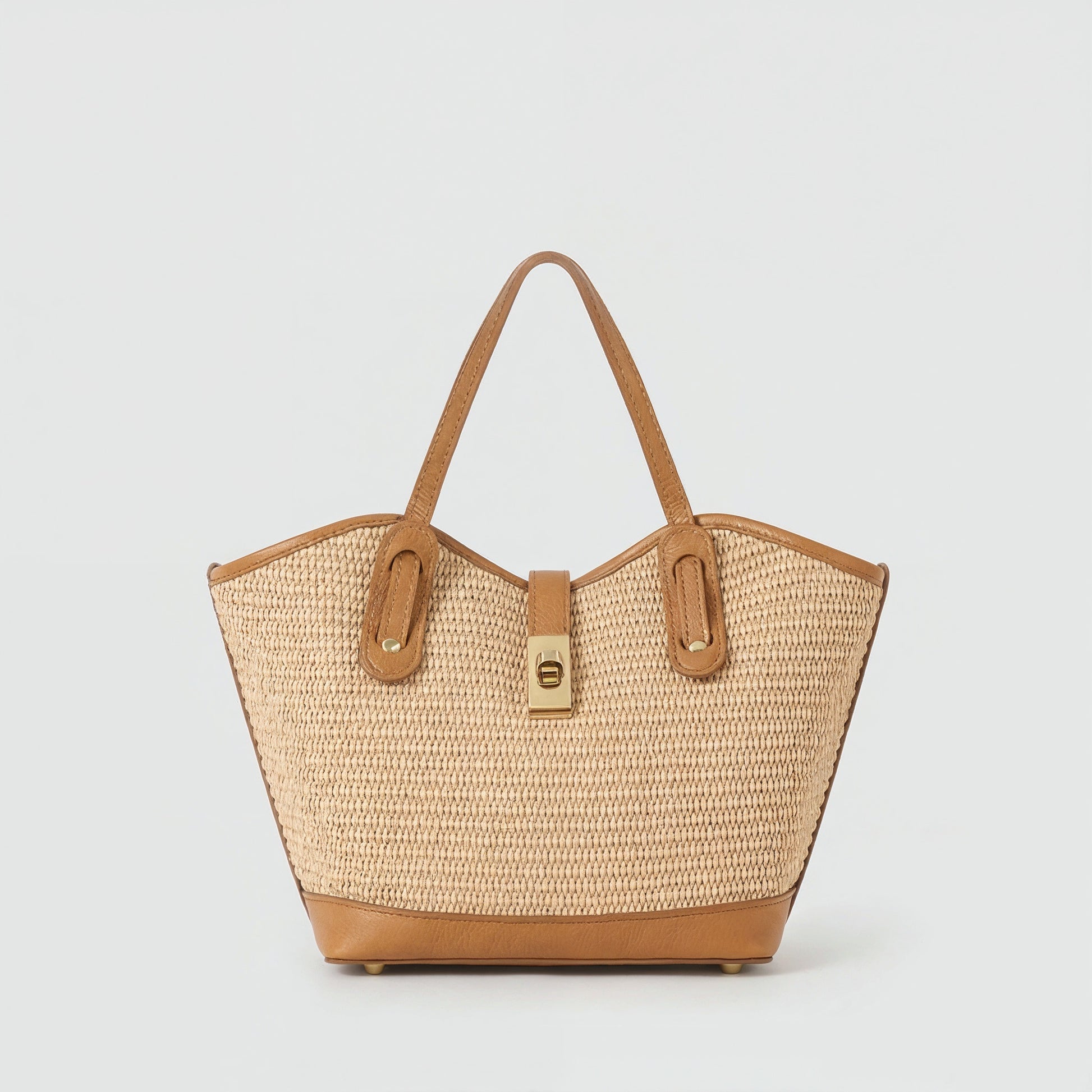 Sorrento raffia and tan leather tote, front view on a light grey studio background