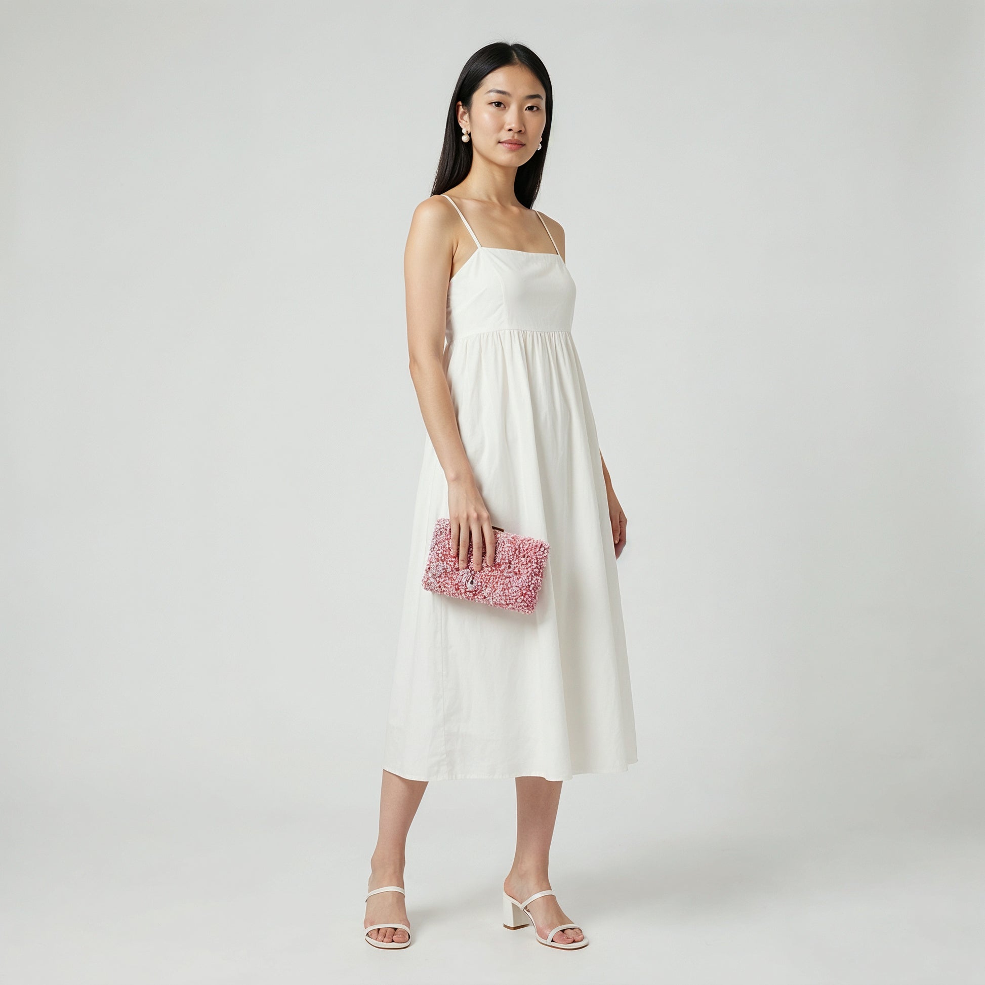 Model holding the Lilac Gemma Natural Stone Box Clutch at her side, studio shot