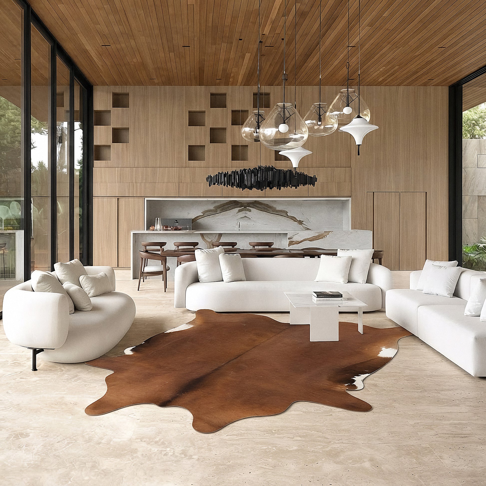 Chestnut brown cowhide rug in a living room with green velvet sofa