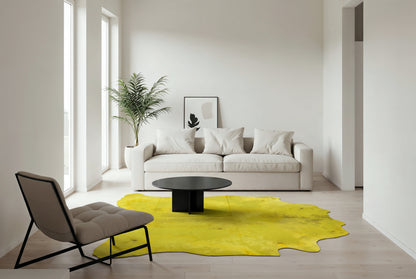 Acid wash yellow Brazilian cowhide rug in a minimalist living room with white sofa