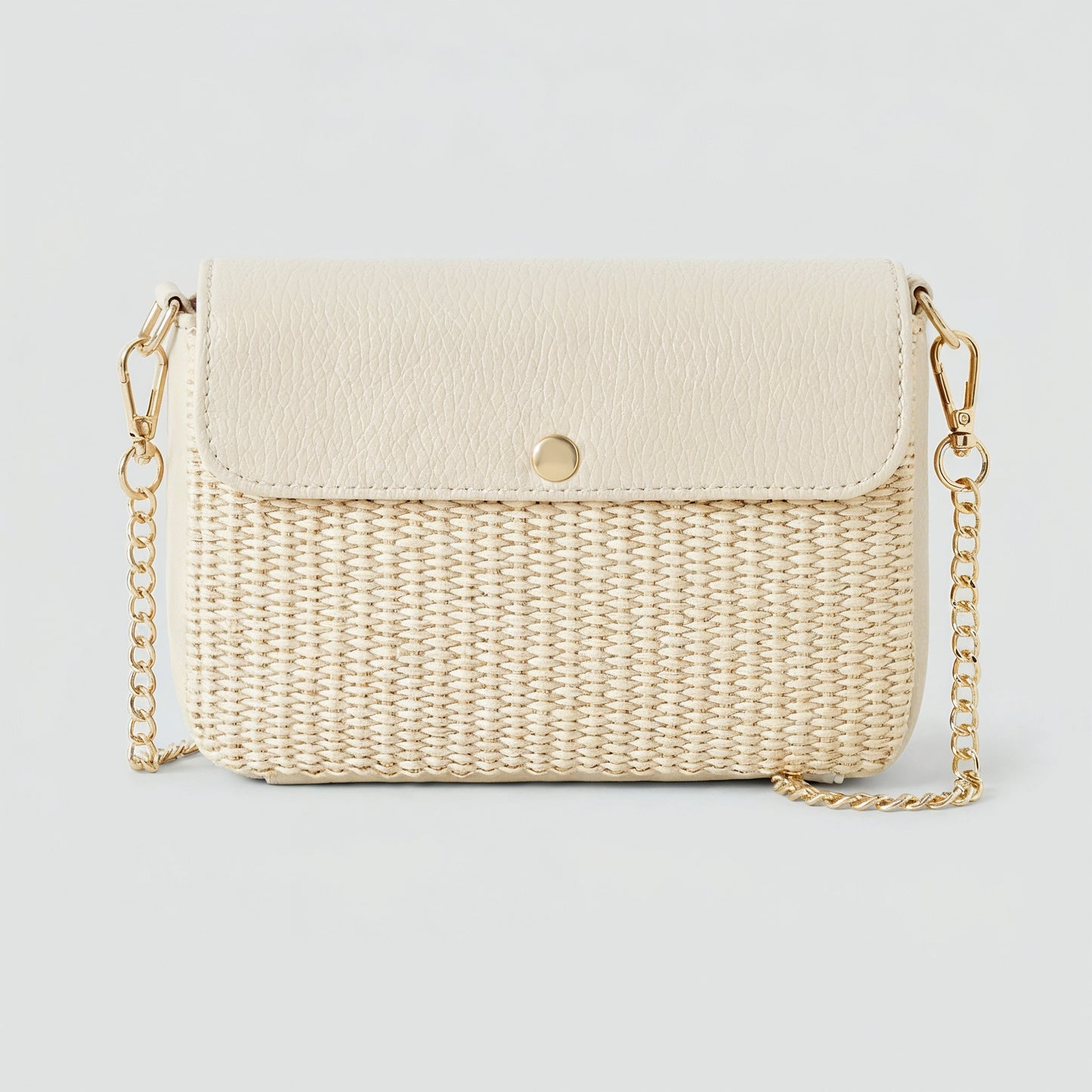 Élodie raffia and leather flap crossbody bag in ivory on a light grey studio background