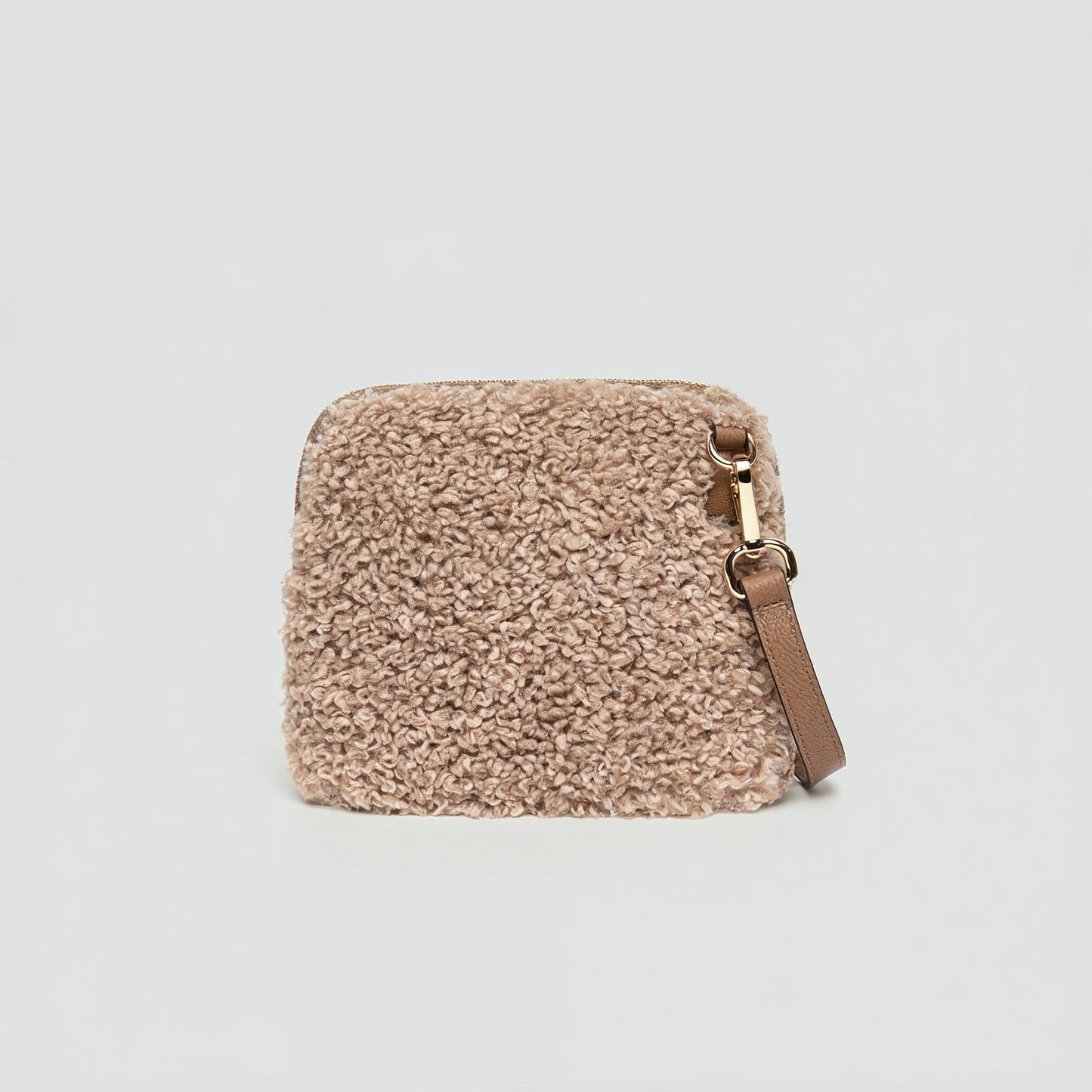 Zita faux shearling crossbody bag in light taupe on a light grey studio background