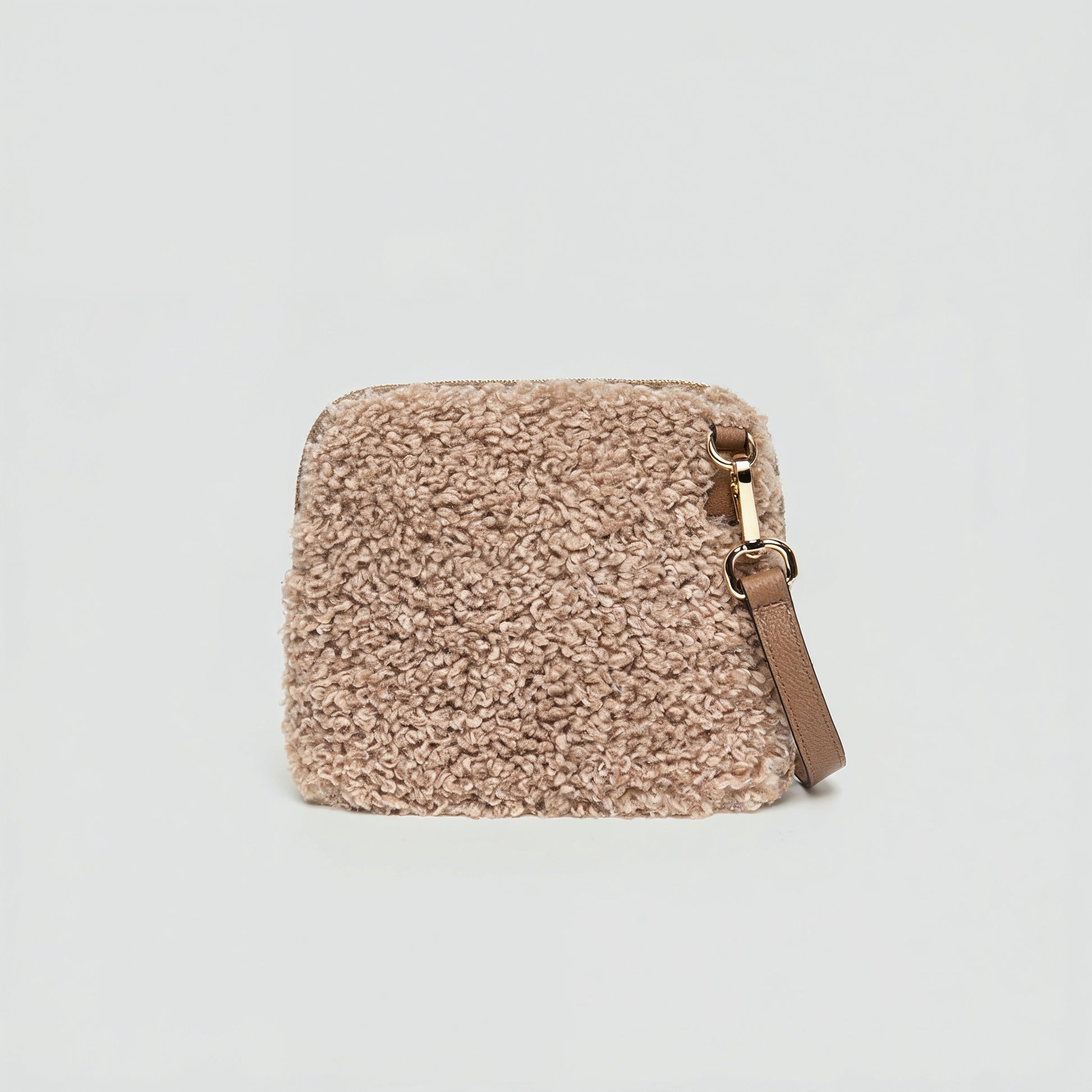Zita faux shearling crossbody bag in light taupe on a light grey studio background