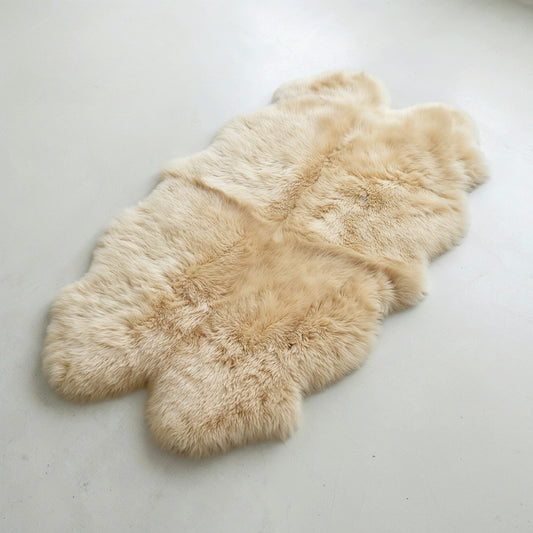 Champagne quad New Zealand sheepskin rug laid flat, four-pelt silhouette