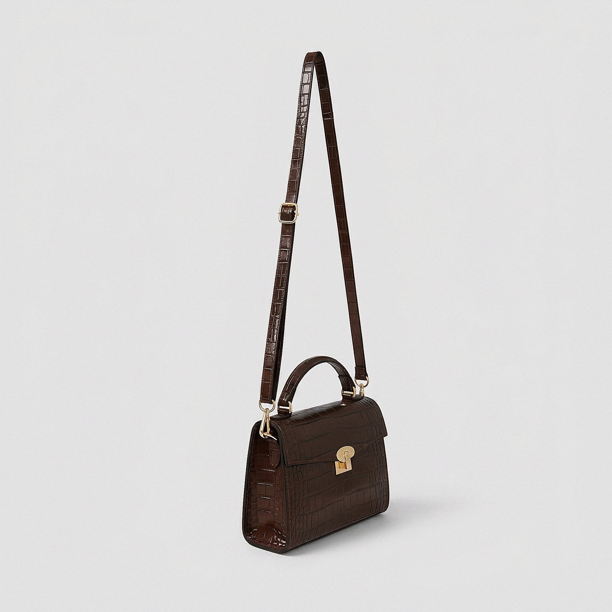 Margot Croc crossbody bag, three-quarter angle with strap raised, studio product photo on grey background