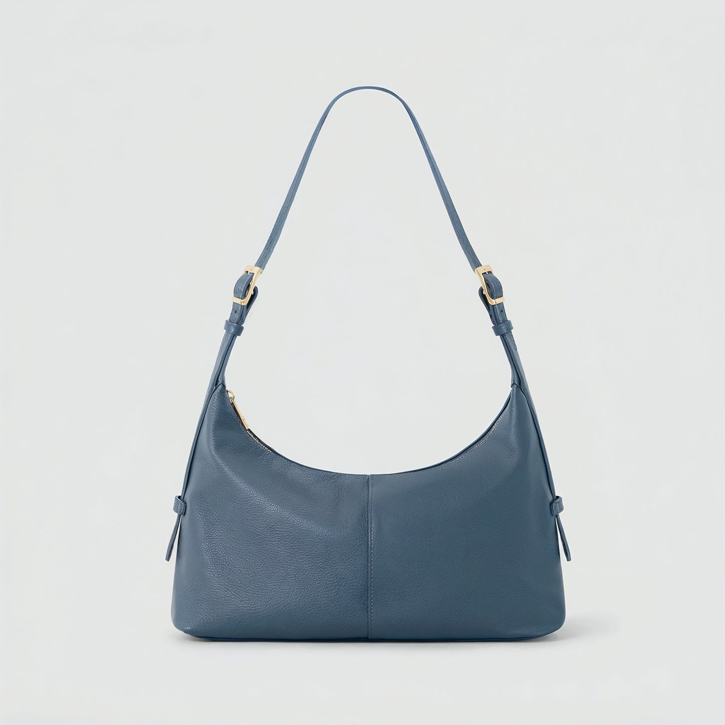 Elettra leather shoulder bag in dusty blue on a light grey studio background
