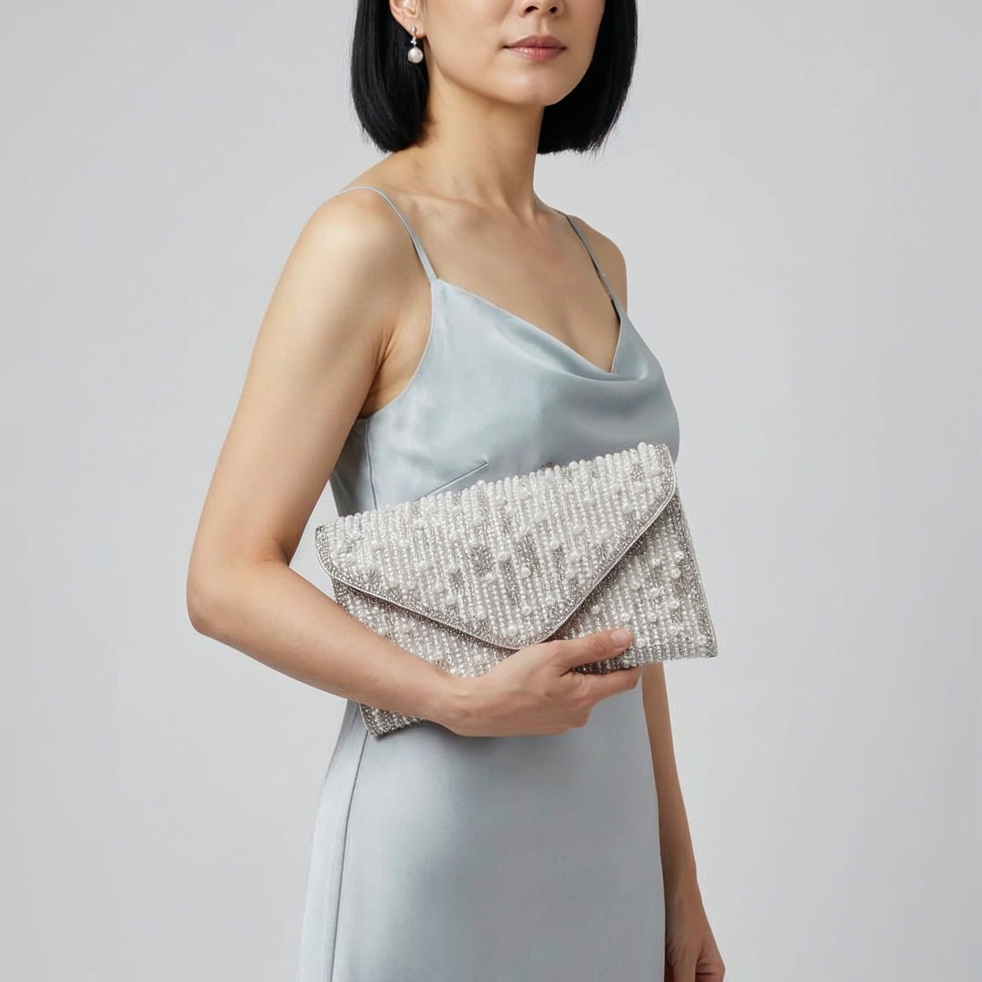 Model with the Silver Perlette Pearl & Crystal Envelope Clutch under her arm, studio shot