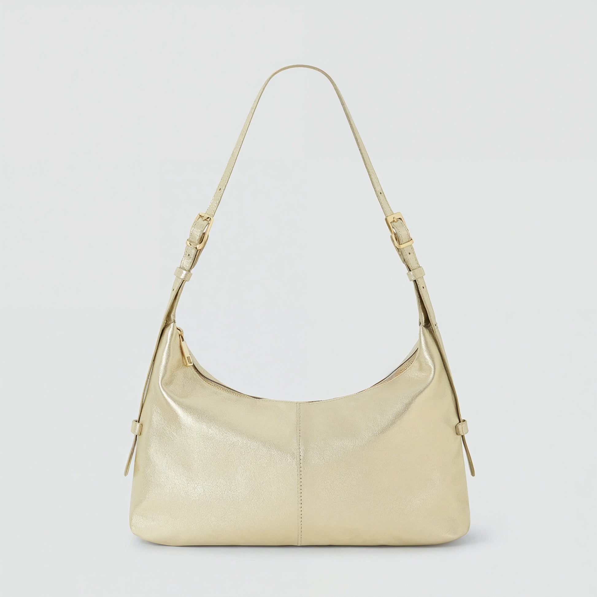 Elettra leather shoulder bag in metallic champagne on a light grey studio background