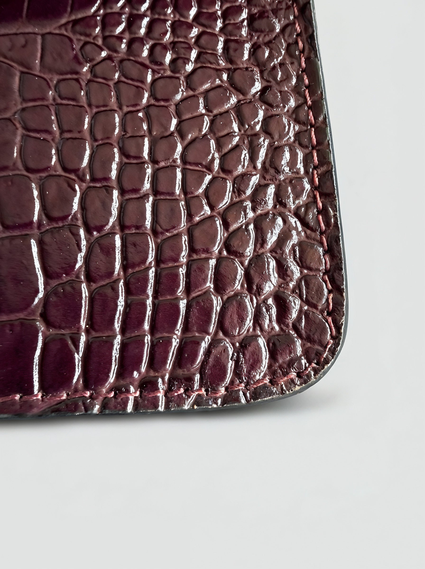 Clotilde Bamboo Croc Handbag by Clemés - Burgundy - close-up of crocodile-embossed leather corner detail