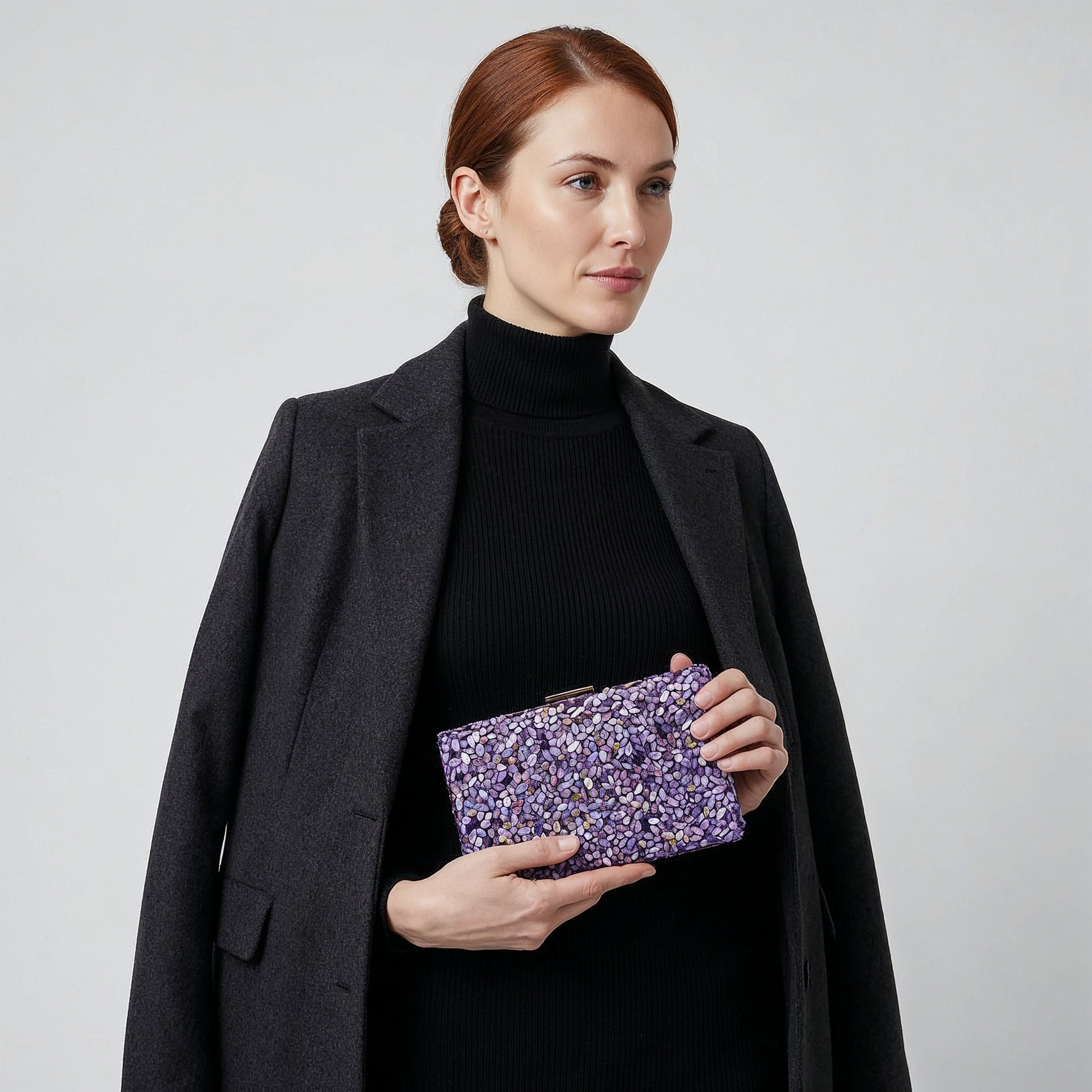 Model holding the Violet Gemma Natural Stone Box Clutch in both hands at waist level, studio shot