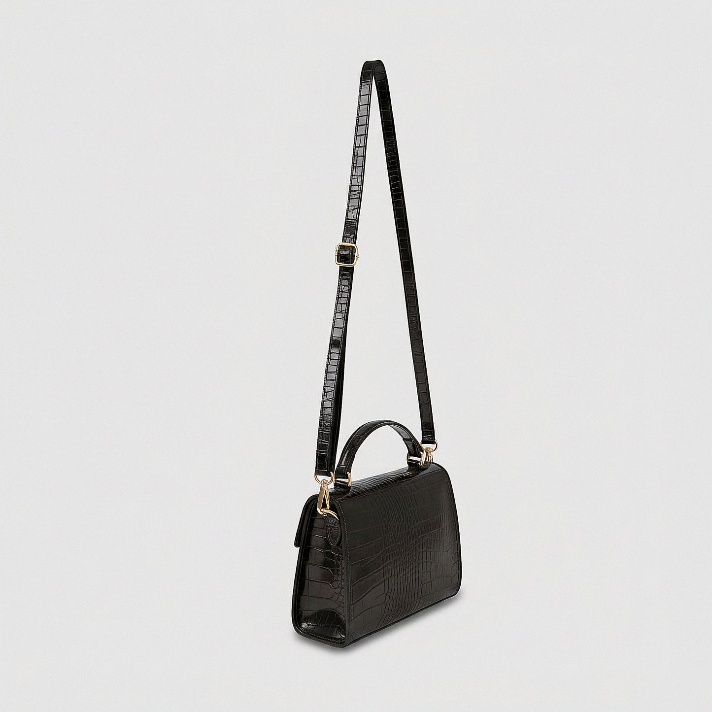Margot Croc crossbody bag, three-quarter angle with strap raised, studio product photo on grey background