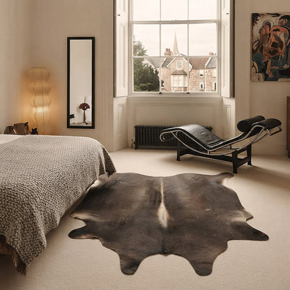 Dark chocolate cowhide rug in an elegant Georgian bedroom