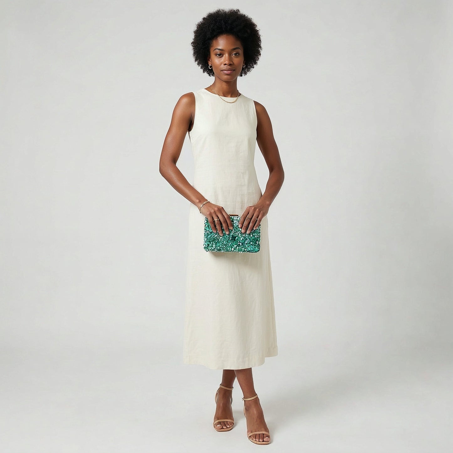 Model holding the Turquoise Gemma Natural Stone Box Clutch in both hands at waist level, studio shot