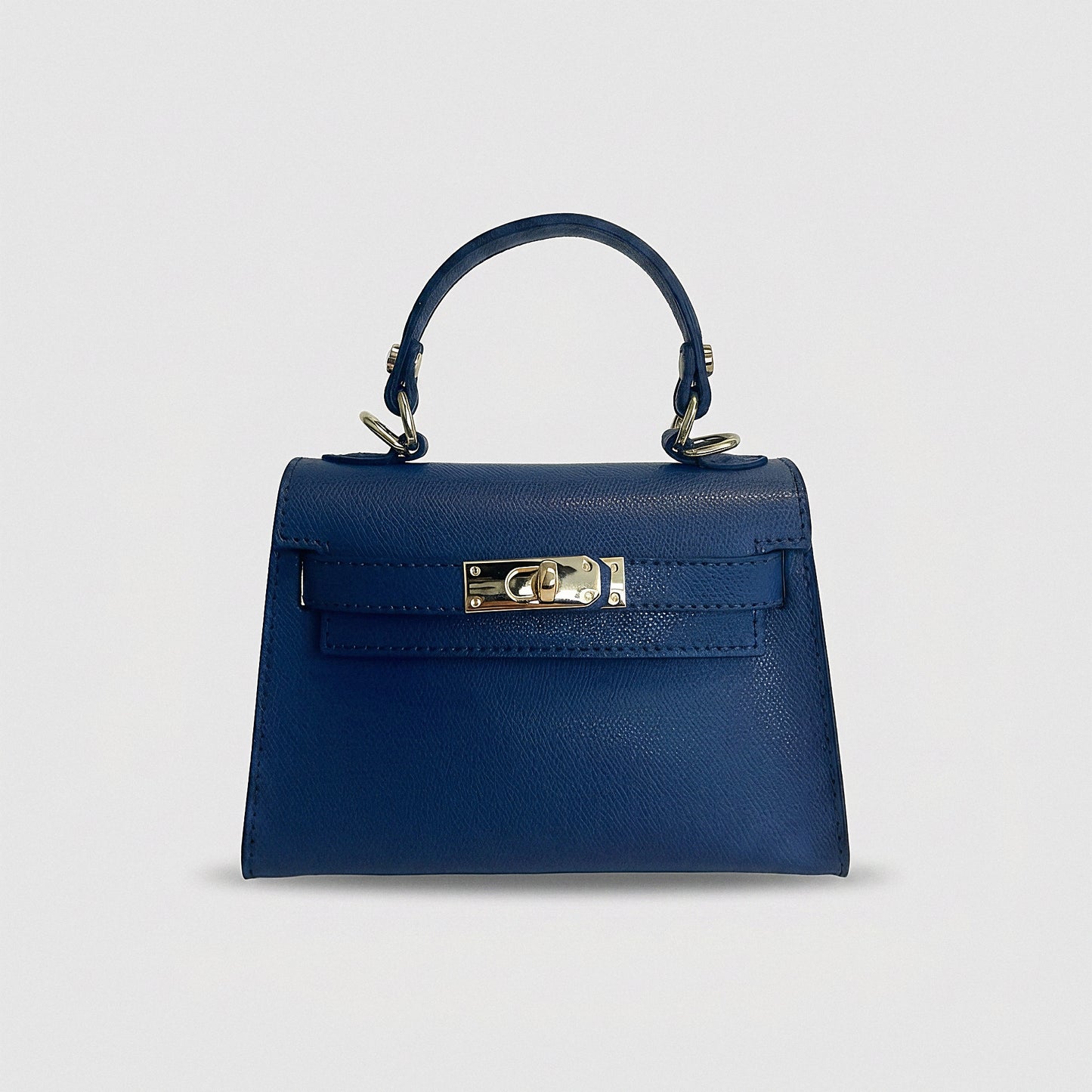 Clemés Mini Kelly mini handbag in blue Epsom leather with gold-tone hardware on a grey studio background