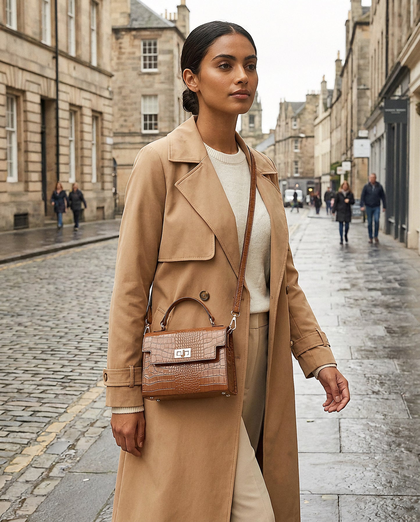 Woman with the Tan Margot Croc crossbody bag on an overcast city street