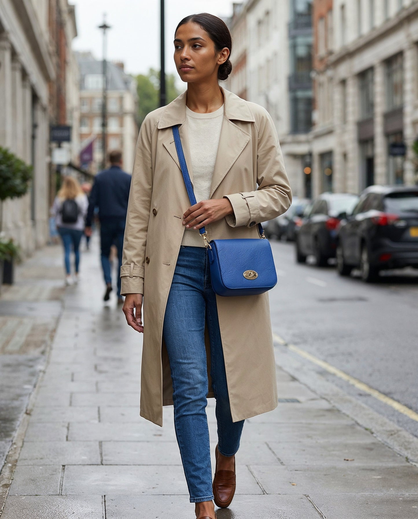 Woman wearing the Royal Blue Chiara crossbody bag on a city street