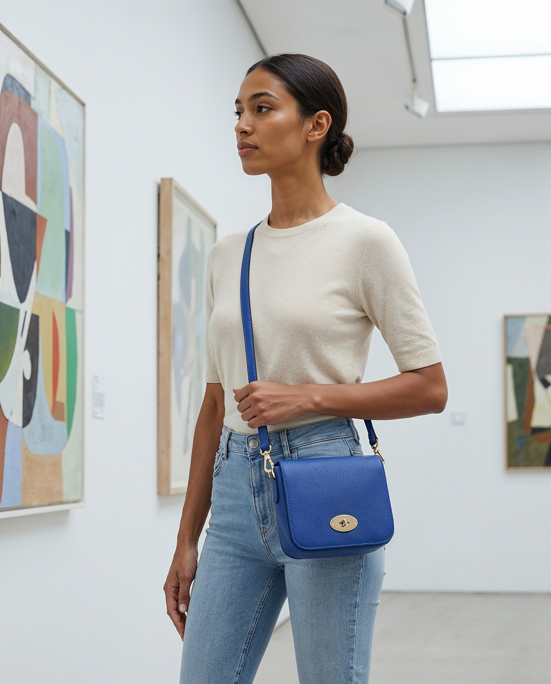 Woman with the Royal Blue Chiara crossbody bag in an art gallery