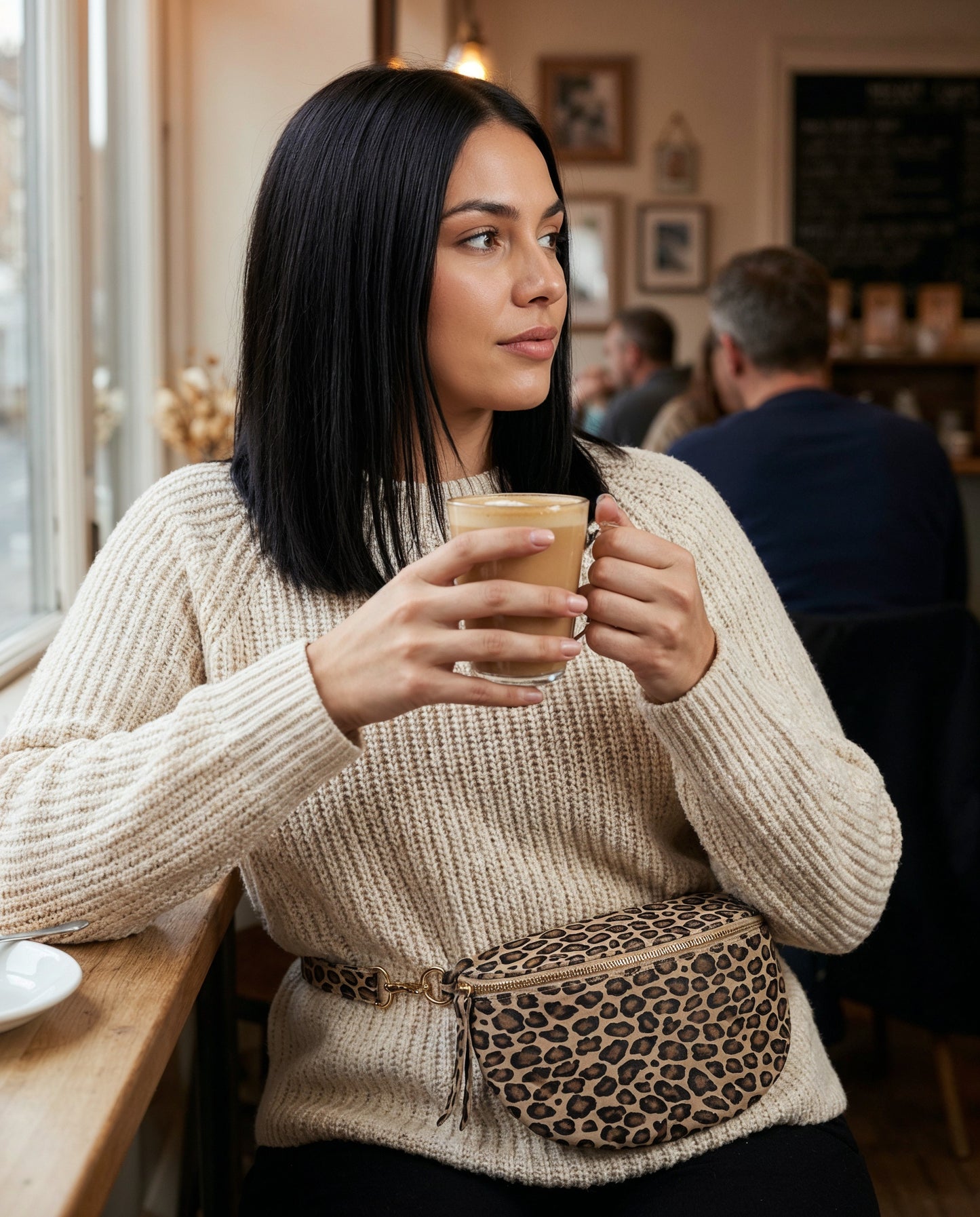 Woman with the Matt Light Taupe Leopard Romy bum bag at a cafe window seat