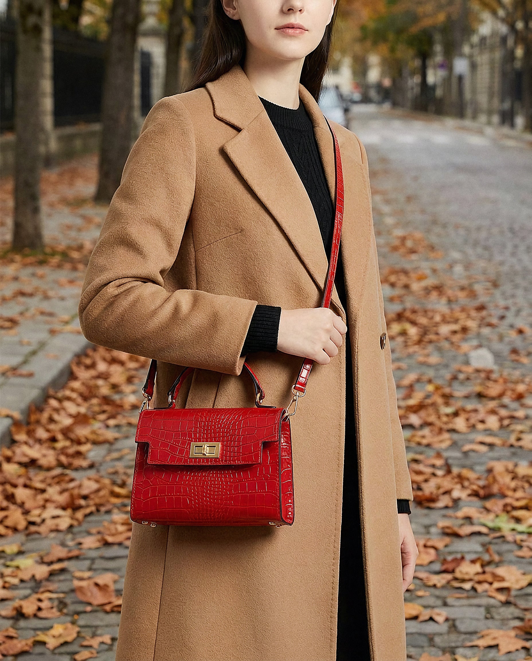 Woman with the Red Margot Croc crossbody bag on an autumn street with fallen leaves