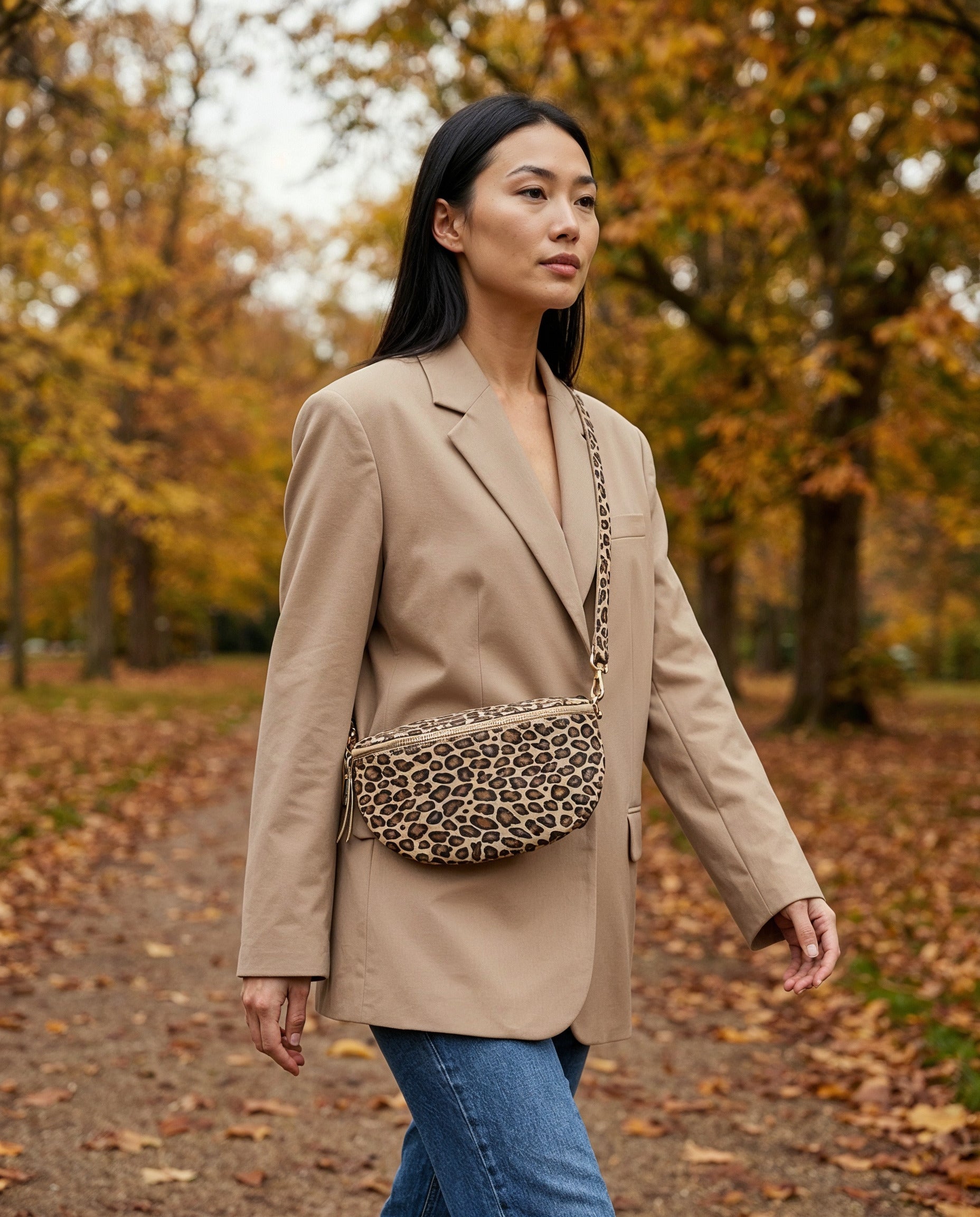 Woman with the Matt Light Taupe Leopard Romy bum bag walking in a park