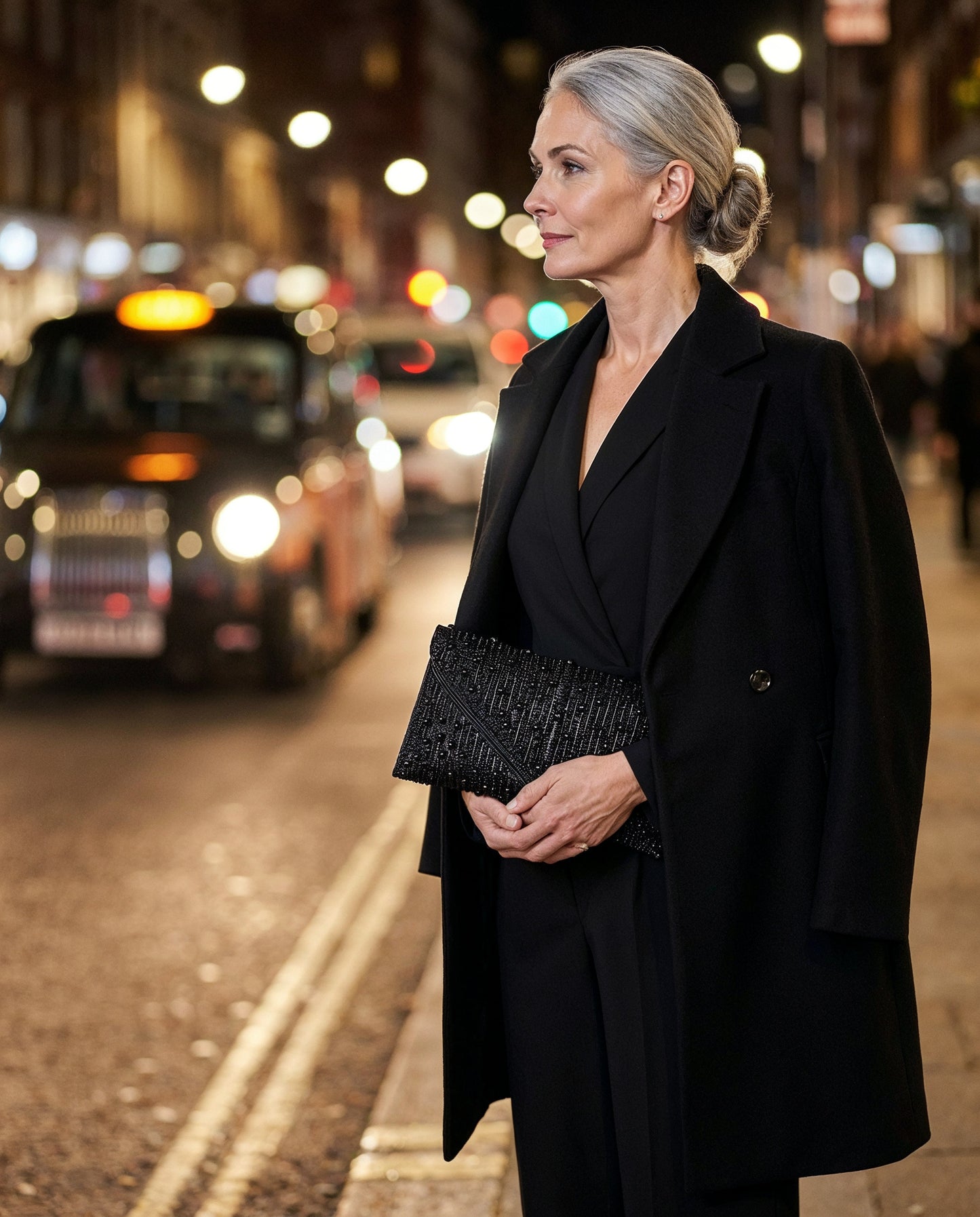 Woman with the Black Perlette Pearl & Crystal Envelope Clutch on an evening city street