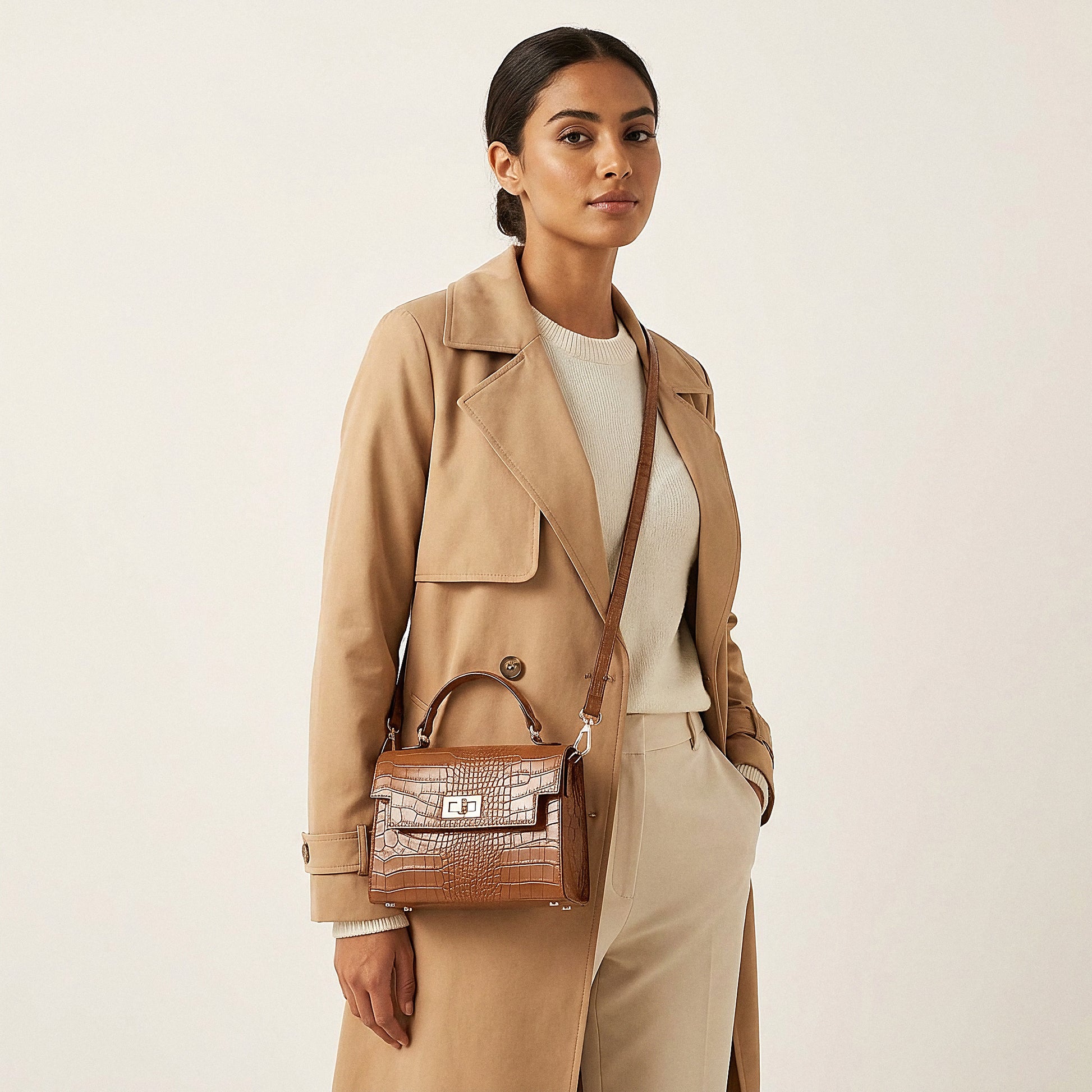 Model carrying the Tan Margot Croc crossbody bag on her shoulder, studio shot