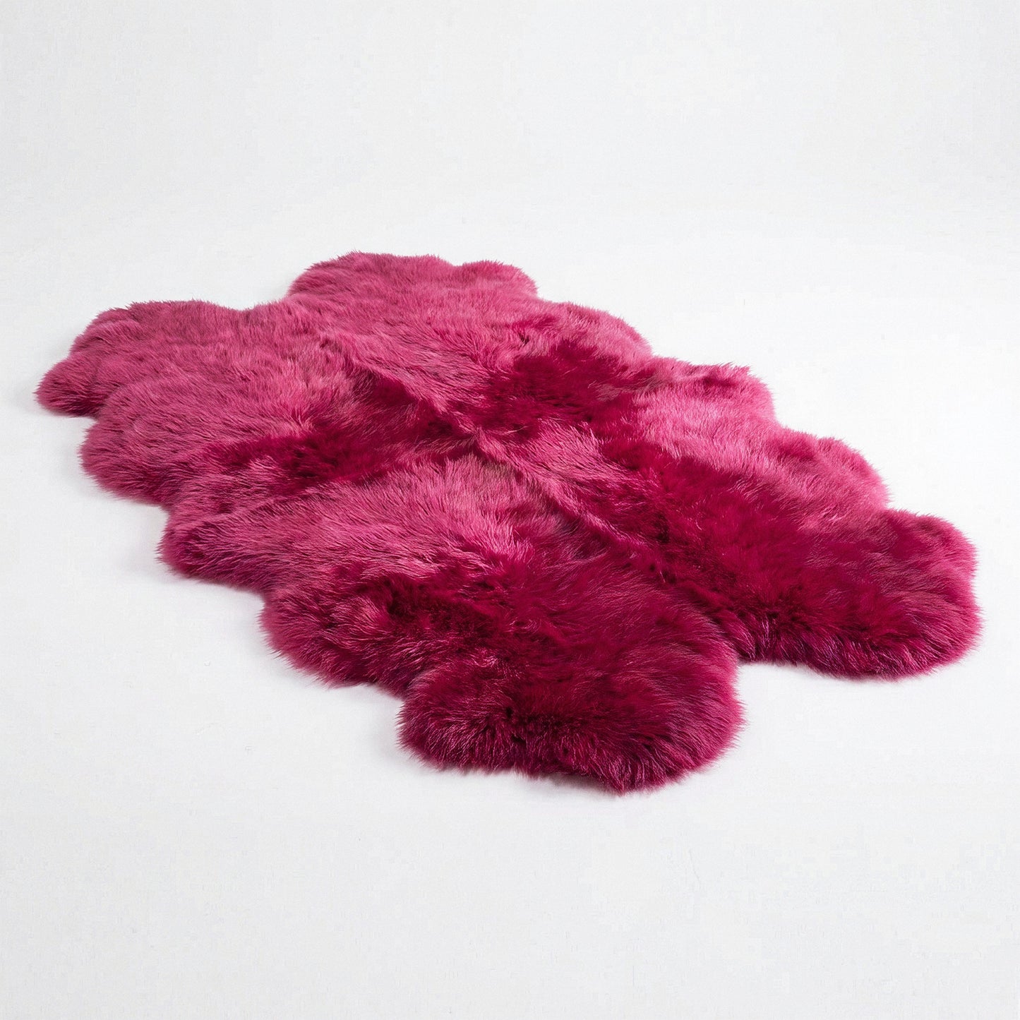 Fuchsia New Zealand sheepskin quad rug, studio shot