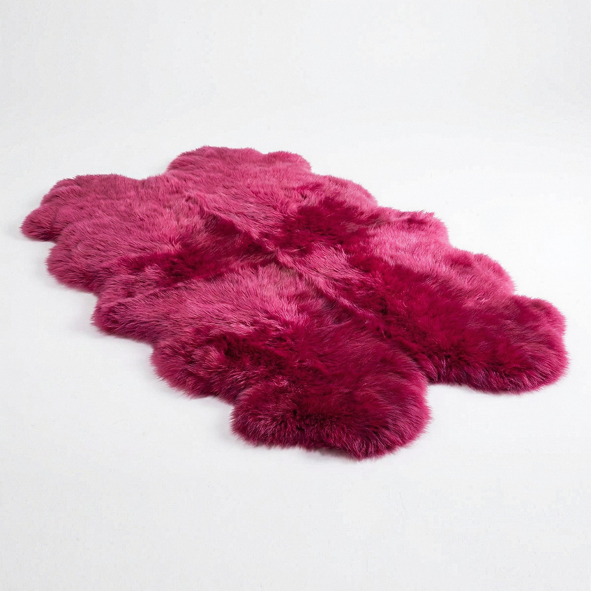Fuchsia New Zealand sheepskin quad rug, studio shot