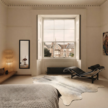 Pale cream cowhide rug in an elegant Georgian bedroom