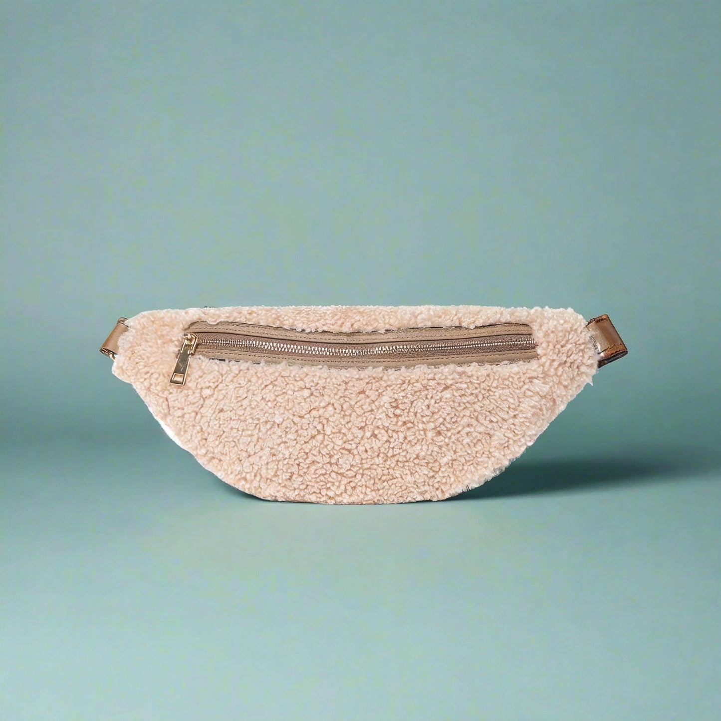 Nevina shearling and leather bum bag in oyster on a teal studio background
