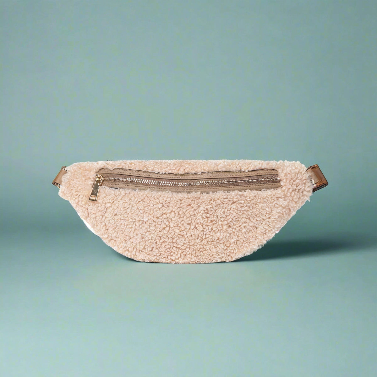 Nevina shearling and leather bum bag in oyster on a teal studio background