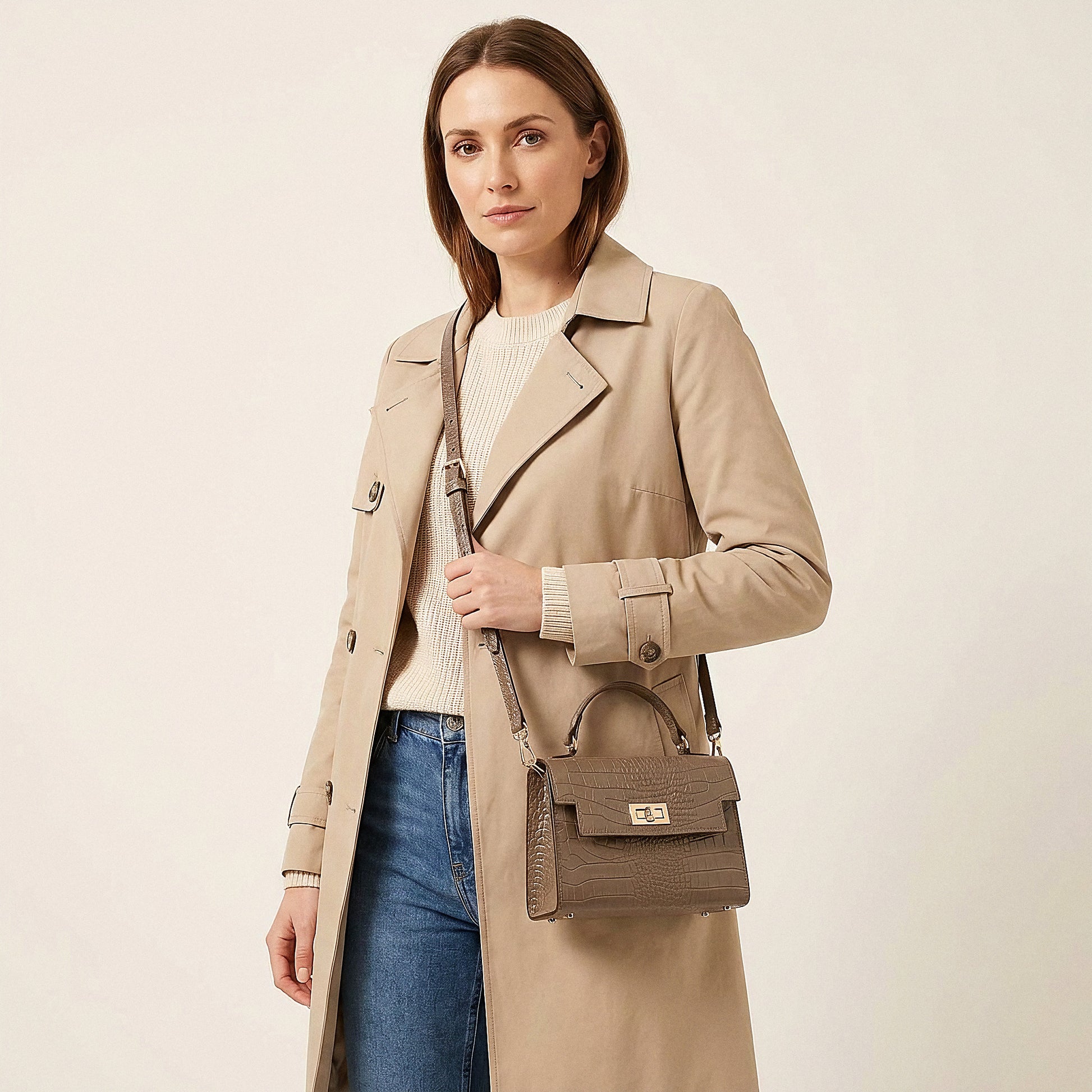 Model carrying the Taupe Margot Croc crossbody bag on her shoulder, studio shot