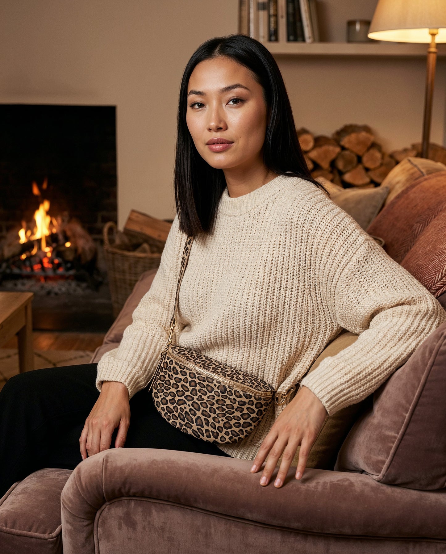 Woman with the Matt Light Taupe Leopard Romy bum bag by a fireside