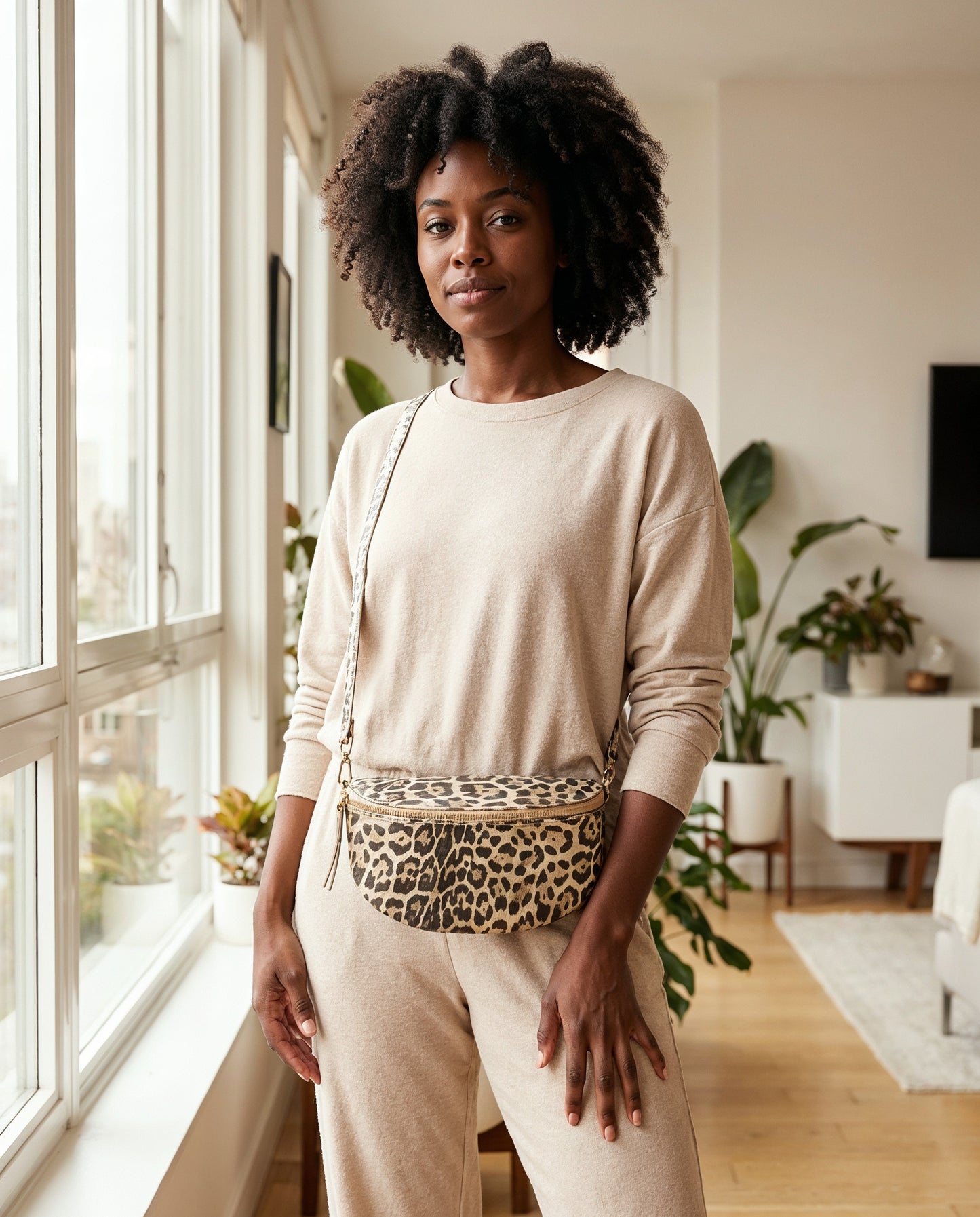 Woman with the Light Gold Leopard Romy bum bag in a bright airy apartment