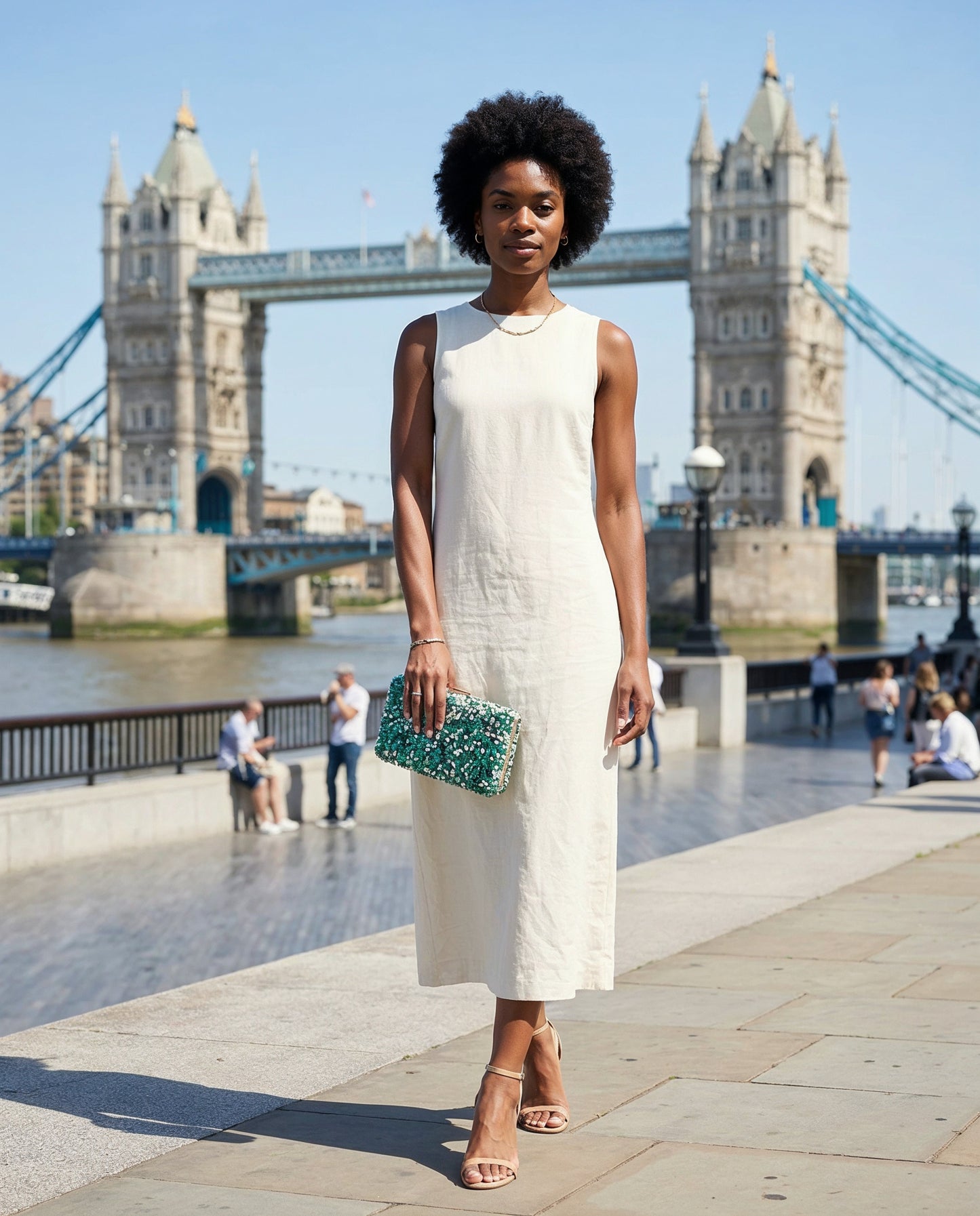Woman carrying the Turquoise Gemma Natural Stone Box Clutch on London's South Bank with Tower Bridge behind