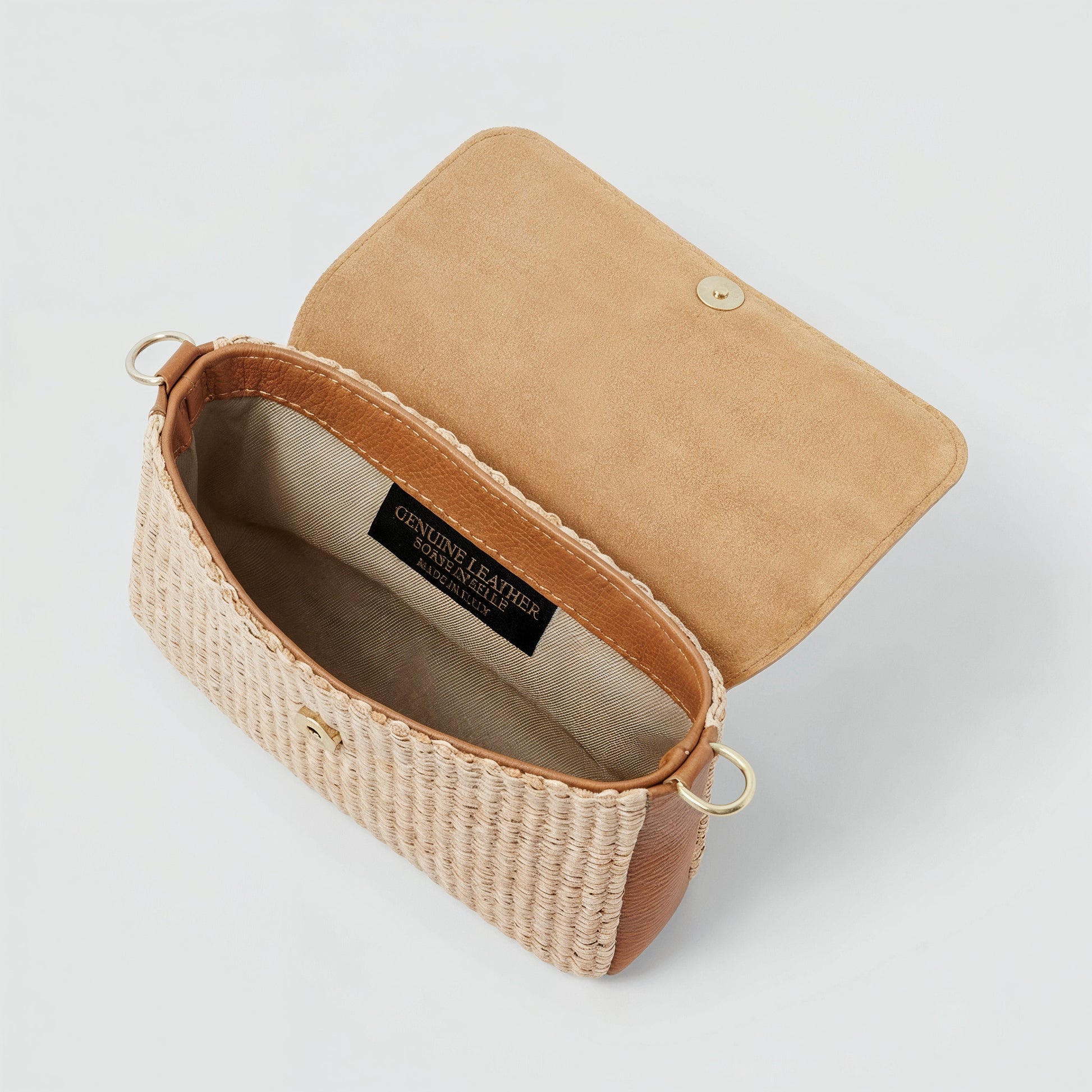 Élodie raffia and leather flap crossbody bag shown open, light grey studio background