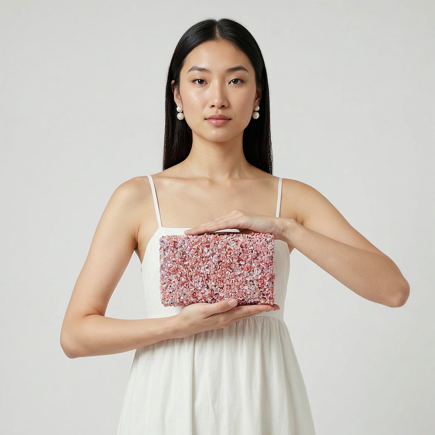 Model presenting the Lilac Gemma Natural Stone Box Clutch on her open palm, studio shot