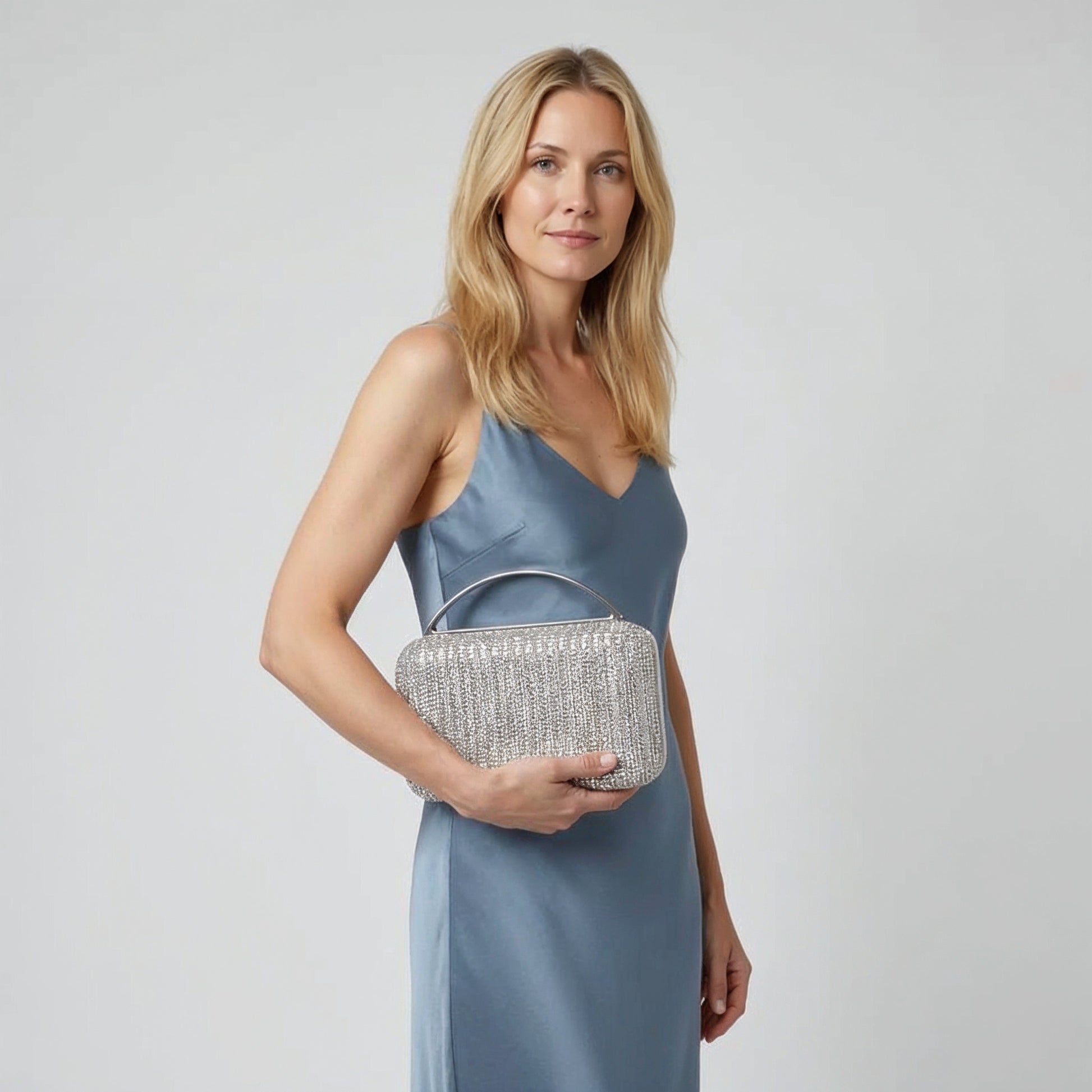 Model with the Silver Odette Crystal Minaudière Clutch under her arm, studio shot