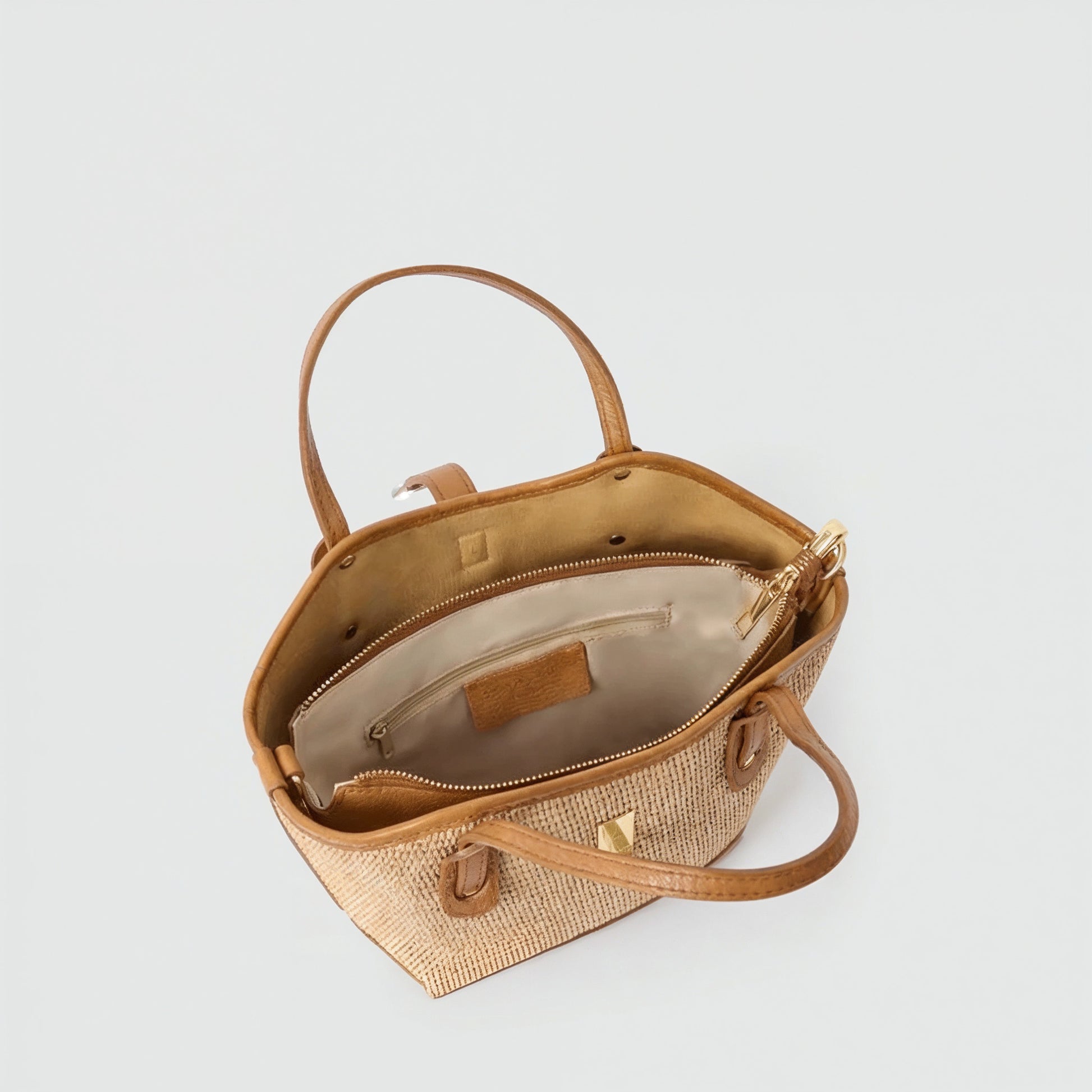 Sorrento raffia tote shown open from above revealing the interior, light grey studio background