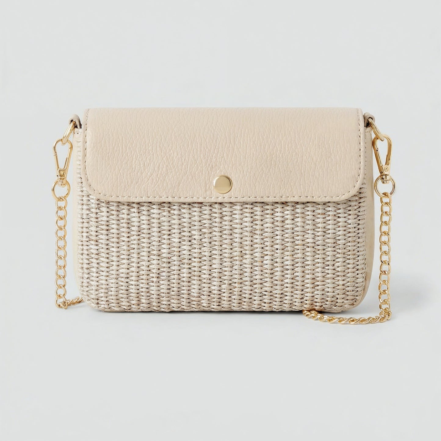 Élodie raffia and leather flap crossbody bag in oyster on a light grey studio background