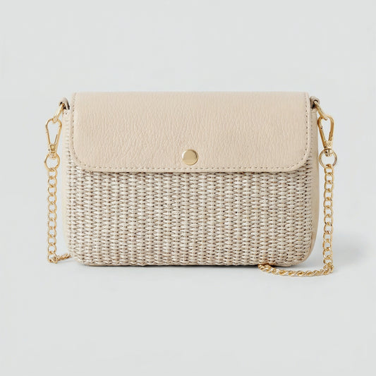 Élodie raffia and leather flap crossbody bag in oyster on a light grey studio background