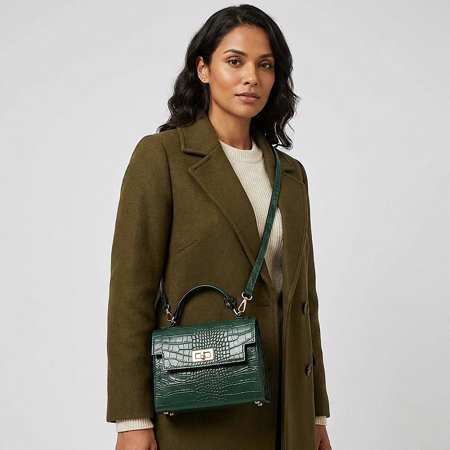 Model carrying the Forest Green Margot Croc crossbody bag on her shoulder, studio shot