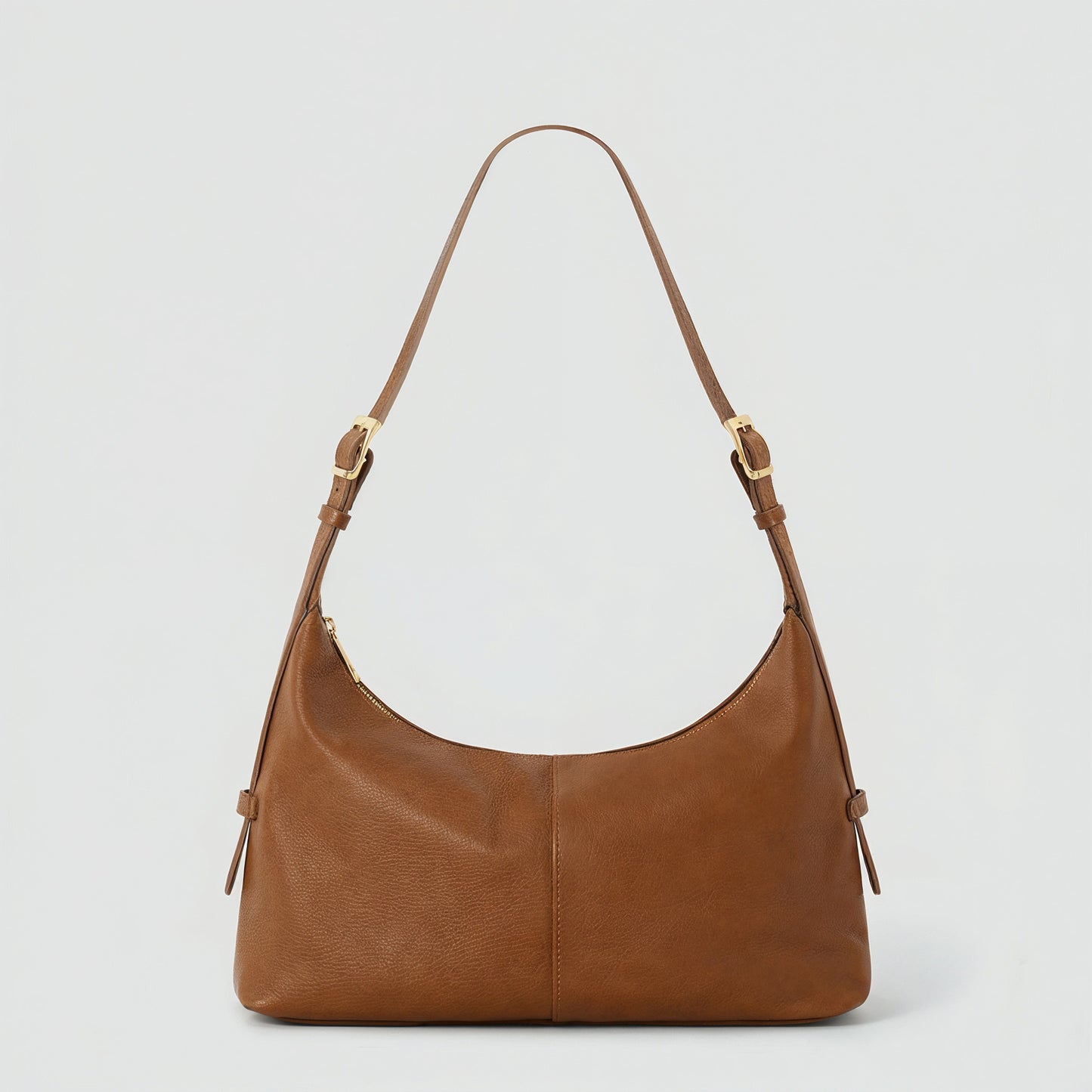 Elettra leather shoulder bag in tan on a light grey studio background