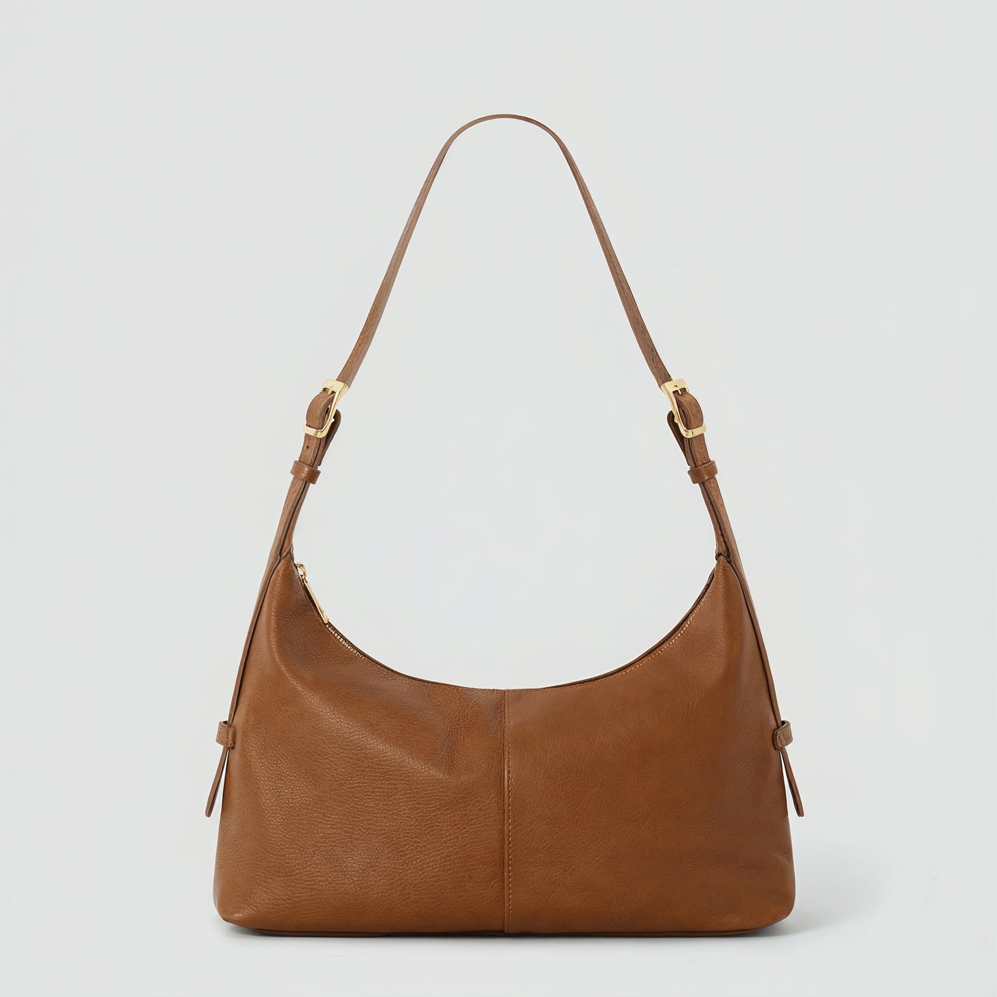 Elettra leather shoulder bag in tan on a light grey studio background