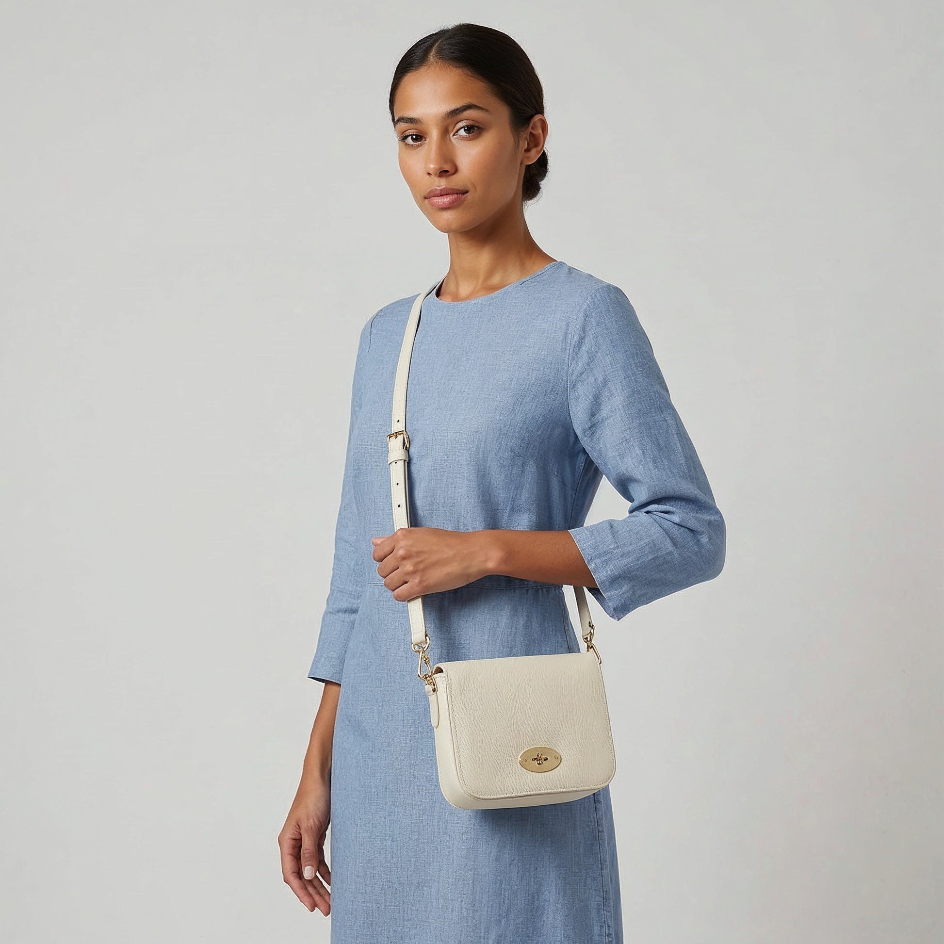Model carrying the Oyster Chiara crossbody bag on her arm, studio shot