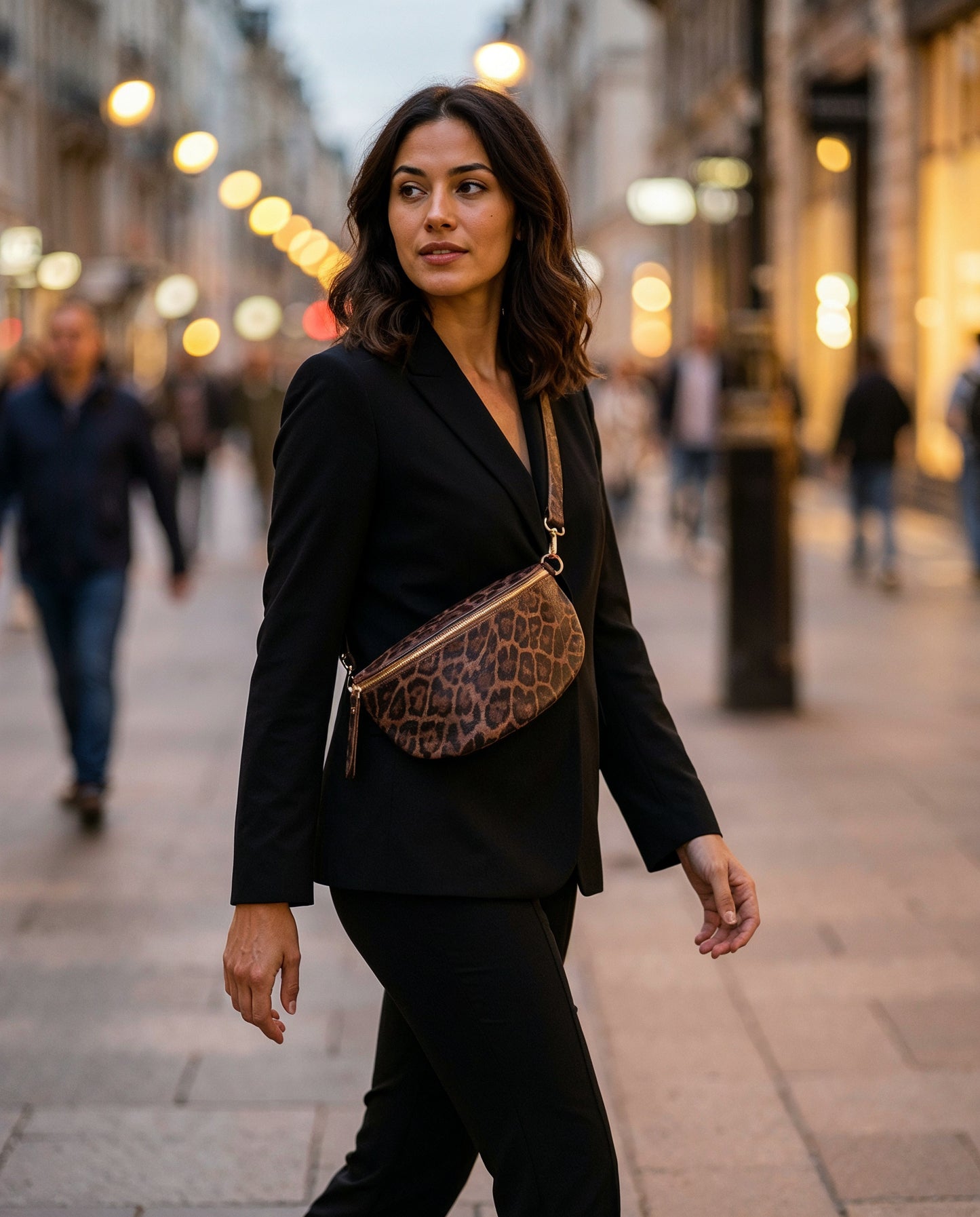 Woman with the Dark Tan Leopard Romy bum bag on an evening city street
