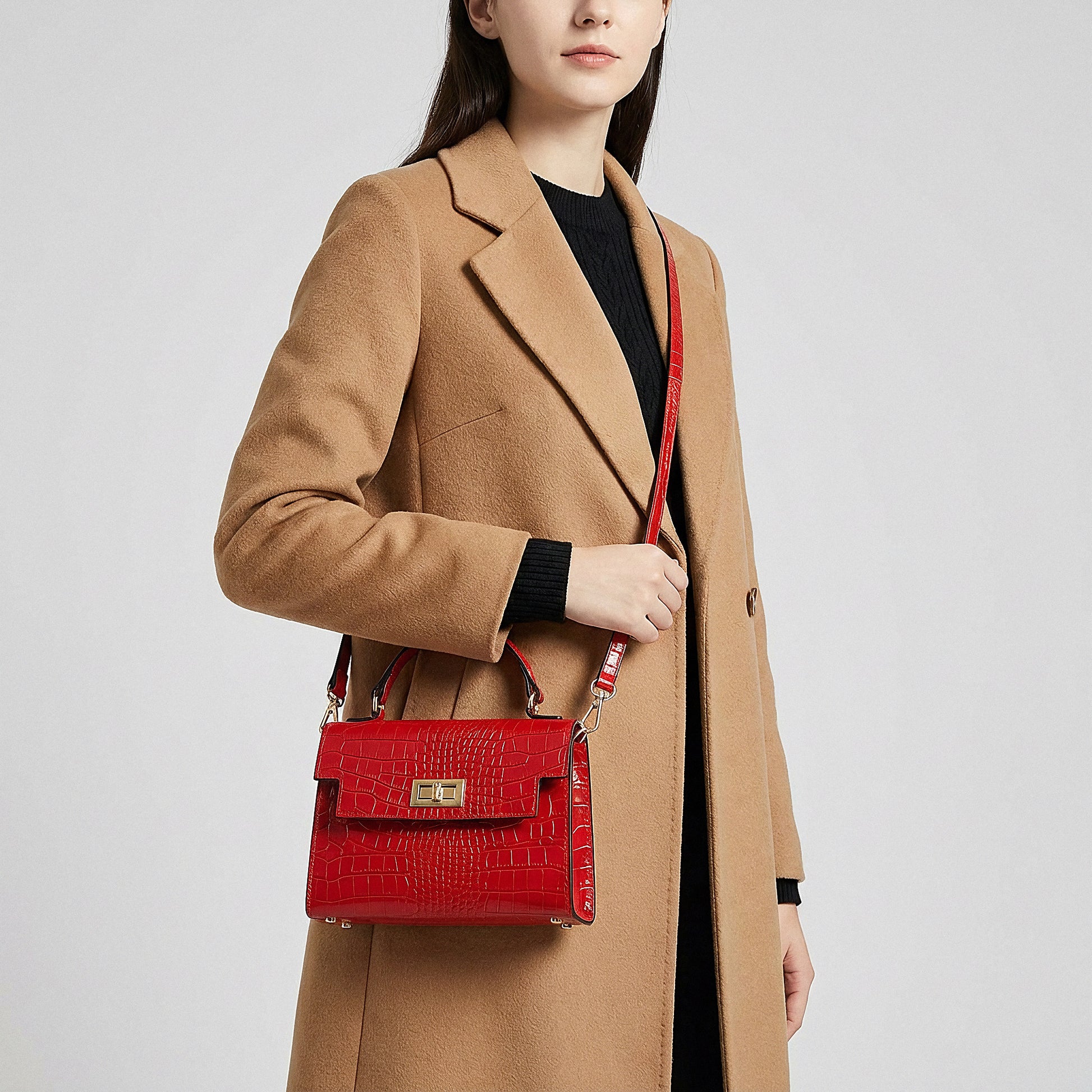 Model carrying the Red Margot Croc crossbody bag on her shoulder, studio shot